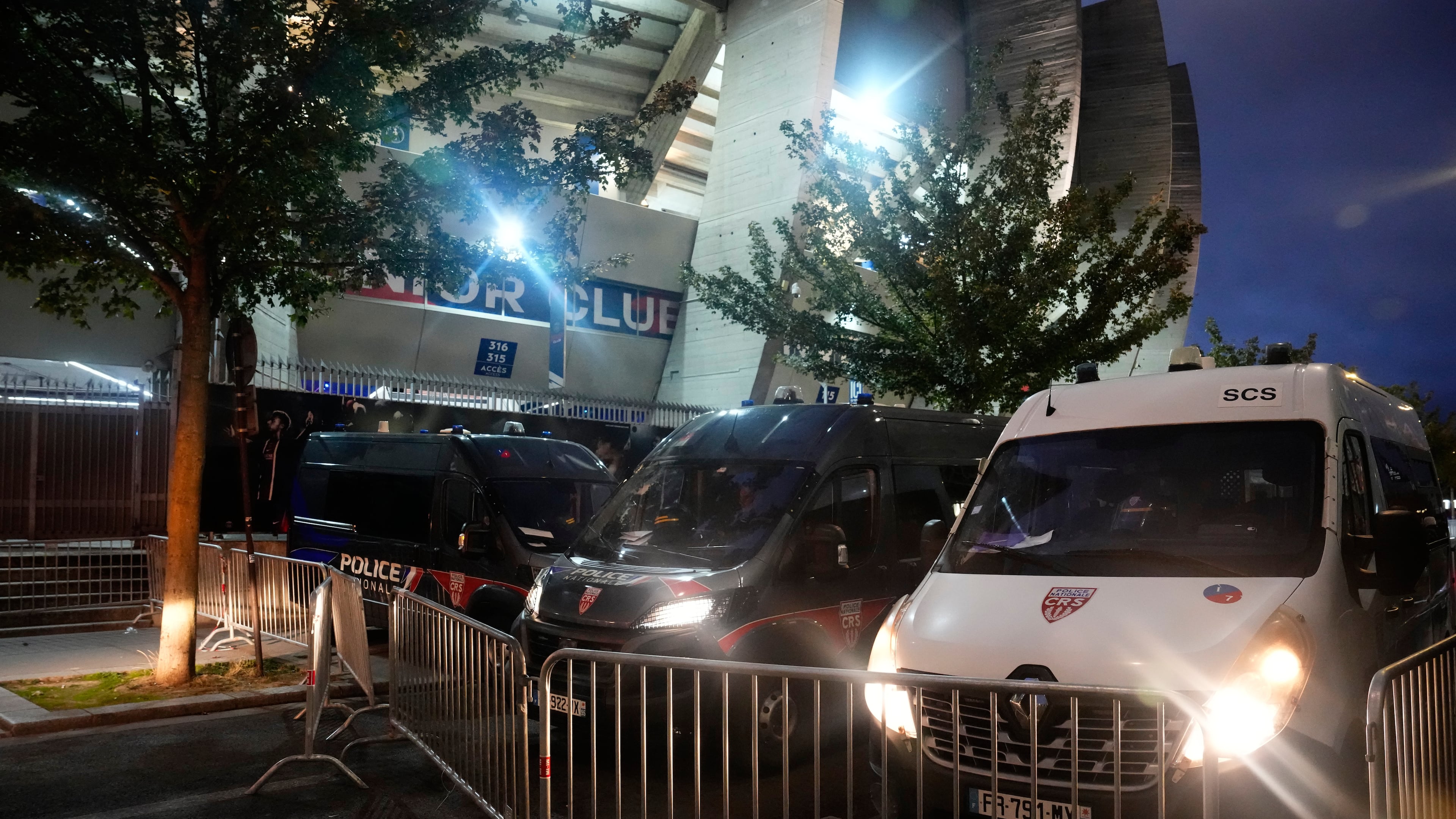 Police vehicles are parked outside the stadium ahead of the Champions League opening phase soccer match between Paris Saint-Germain and FC Barcelona in Paris, Tuesday, Oct. 20, 2026. (AP Photo/Teresa Suarez)