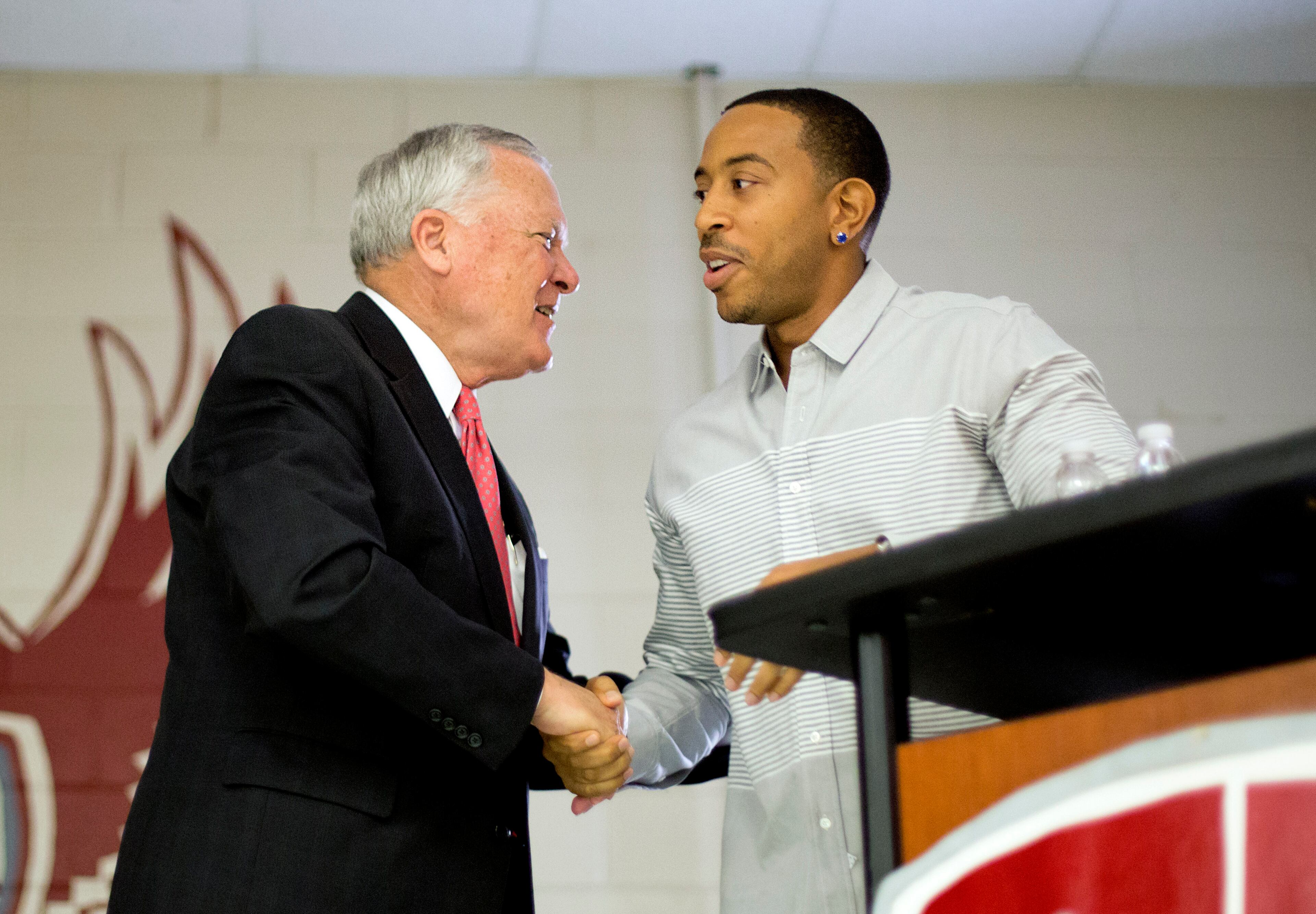 Rapper Ludacris, right, shakes hands with Georgia Gov. Nathan Deal while visiting the charter school Utopian Academy for the Arts, Friday, Sept. 26, 2014, in Riverdale, Ga. Deal and Ludacris may seem like an odd pairing for a campaign event, but the duo was a hit with a cheering crowd of students Friday. Christopher "Ludacris" Bridges has been an outspoken supporter of President Barack Obama, penning a profane song during the 2008 campaign criticizing his opponents. But Deal says he couldn't think of anyone better to inspire students at the event. (AP Photo/David Goldman)