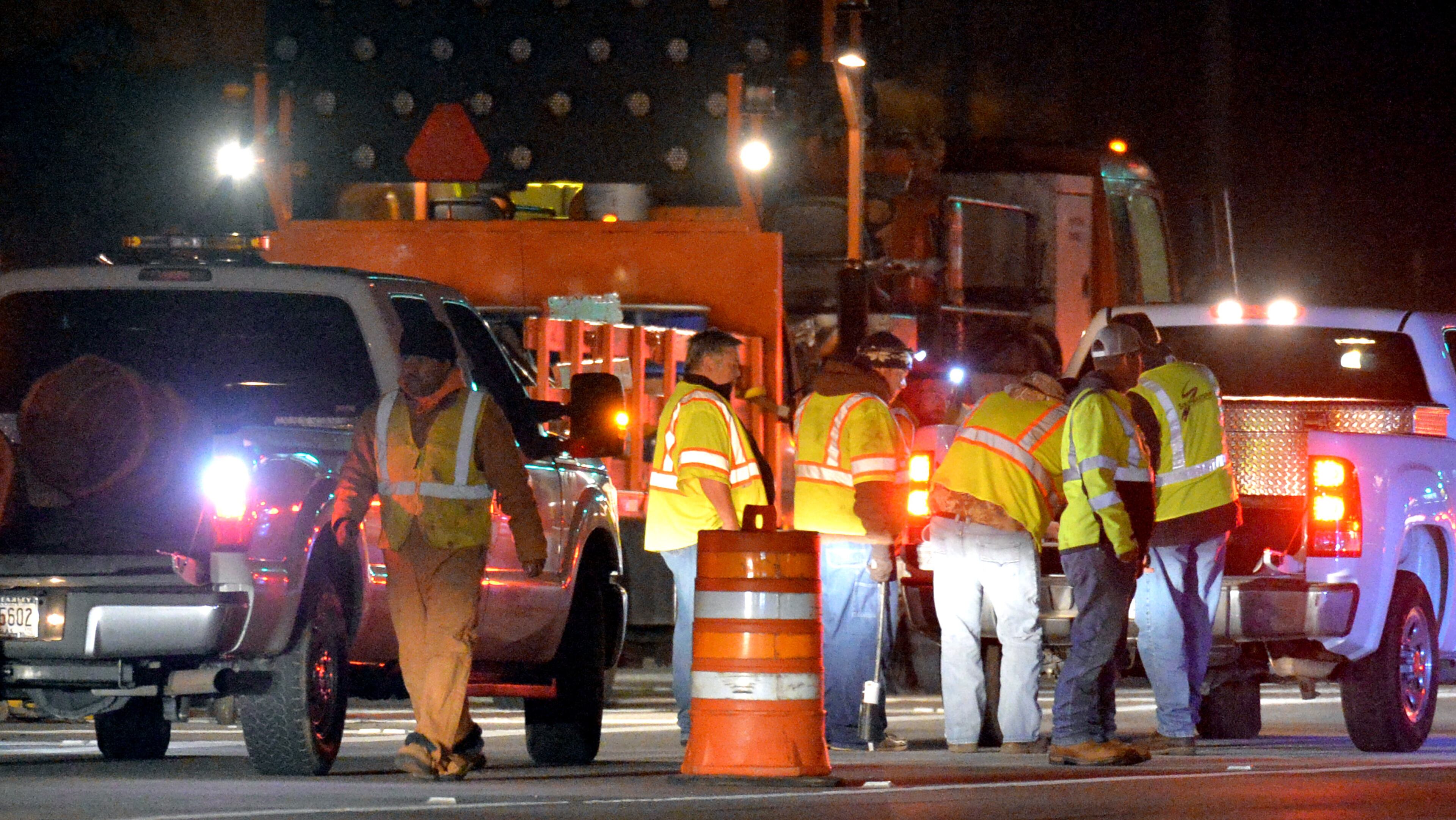 Road crews work as Georgia Department of Transportation closes two northbound lanes near Georgia 400 toll booths on Friday, October 25, 2013. The first phase of a four-phase demolition project began on Friday, October 25, 2013, with restriping in the Peach Pass electronic toll lanes and modification/removal of redundant signage. Phase I of the project will include the restriping in the electronic Peach Pass lanes and the start of the removal or modification of toll-related signage from areas approaching the GA 400 Toll Plaza within the next two to three weeks.