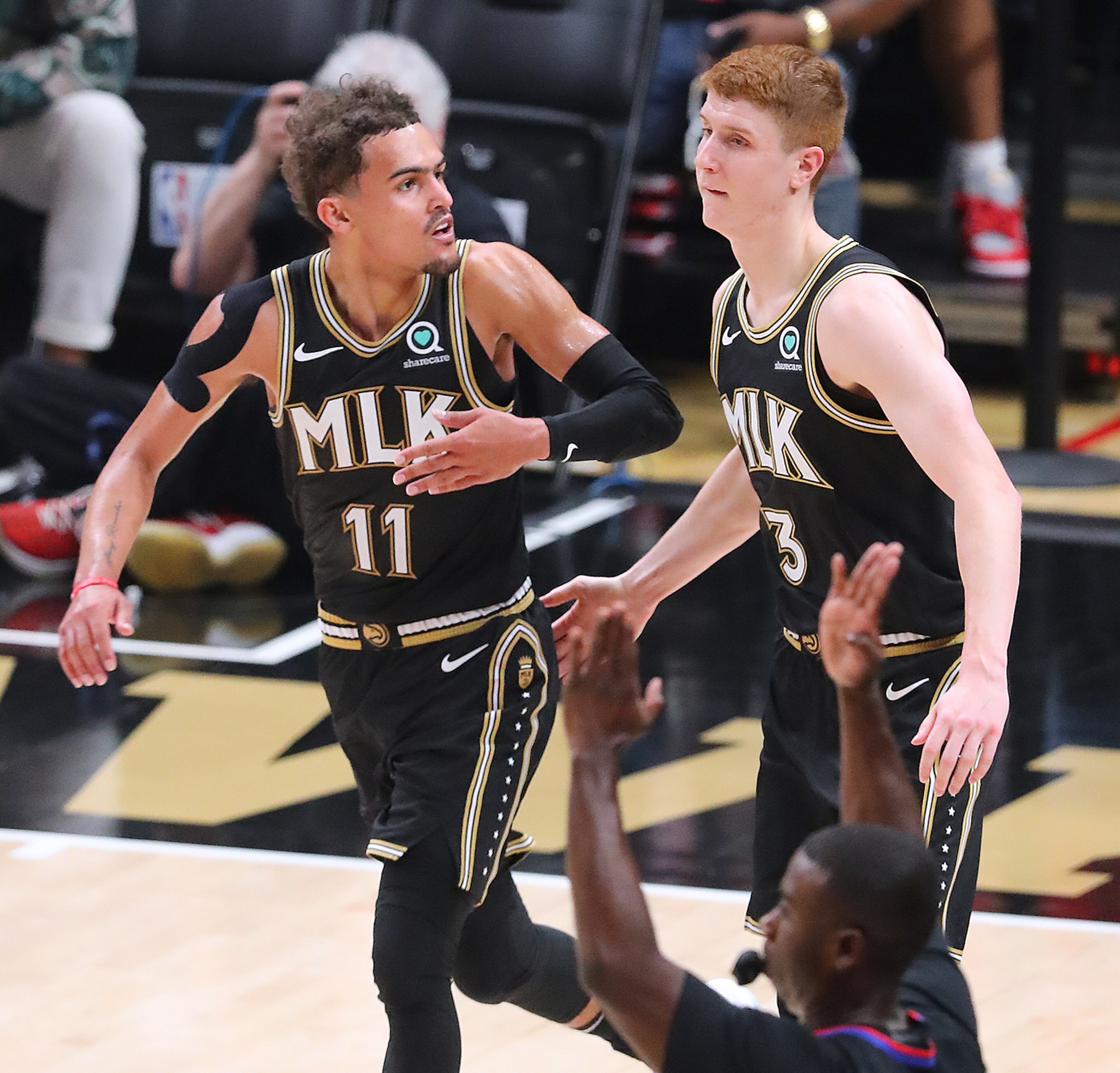 Atlanta Hawks guards Trae Young Kevin Huerter exchange five after a pass from Young to Huerter for a three-point basket. “Curtis Compton / Curtis.Compton@ajc.com”