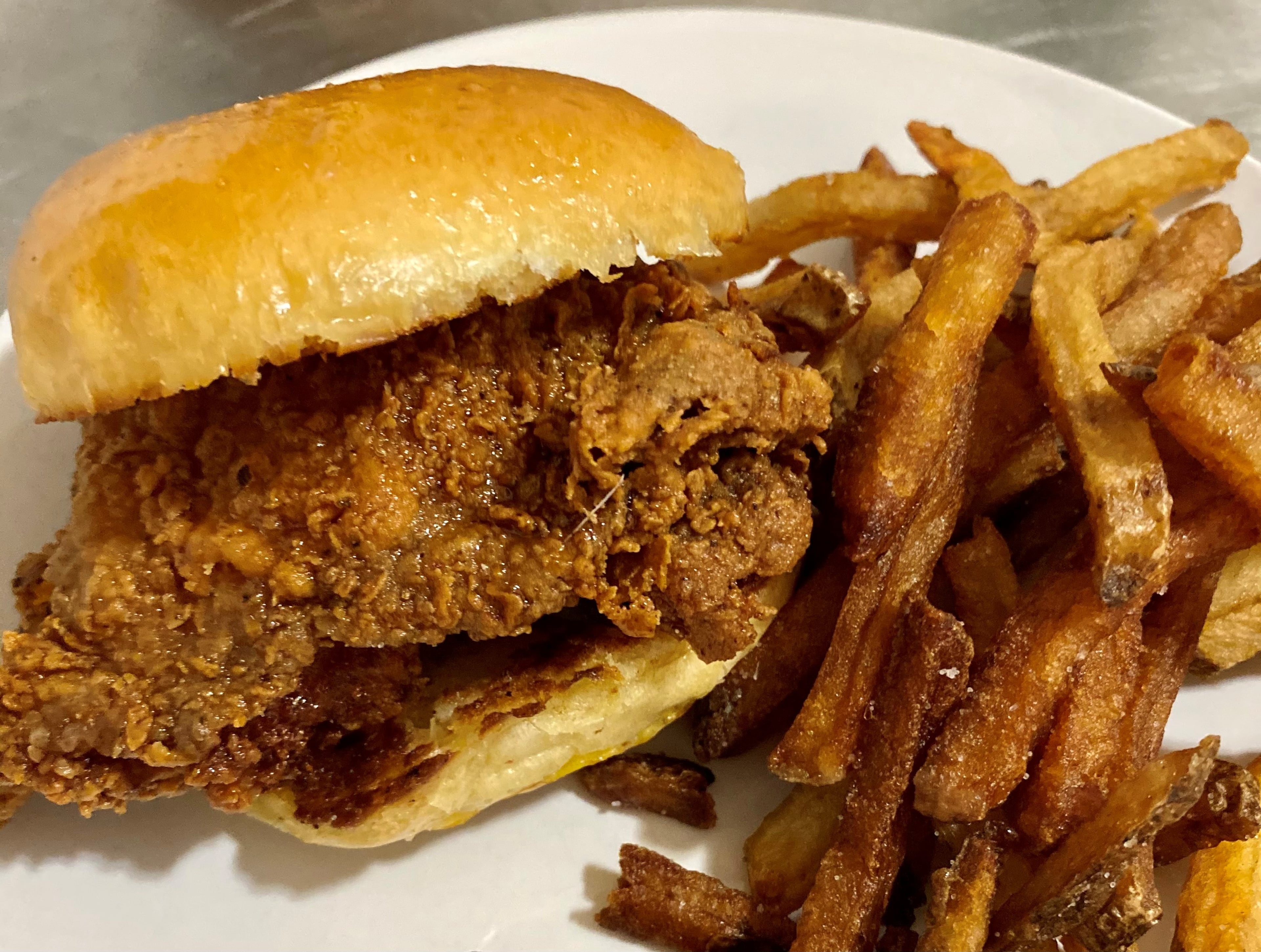 Argosy in East Atlanta Village does hot chicken right. This sandwich is made with a chicken thigh, fried to perfection, then doused with ghost honey.
Wendell Brock for The Atlanta Journal-Constitution