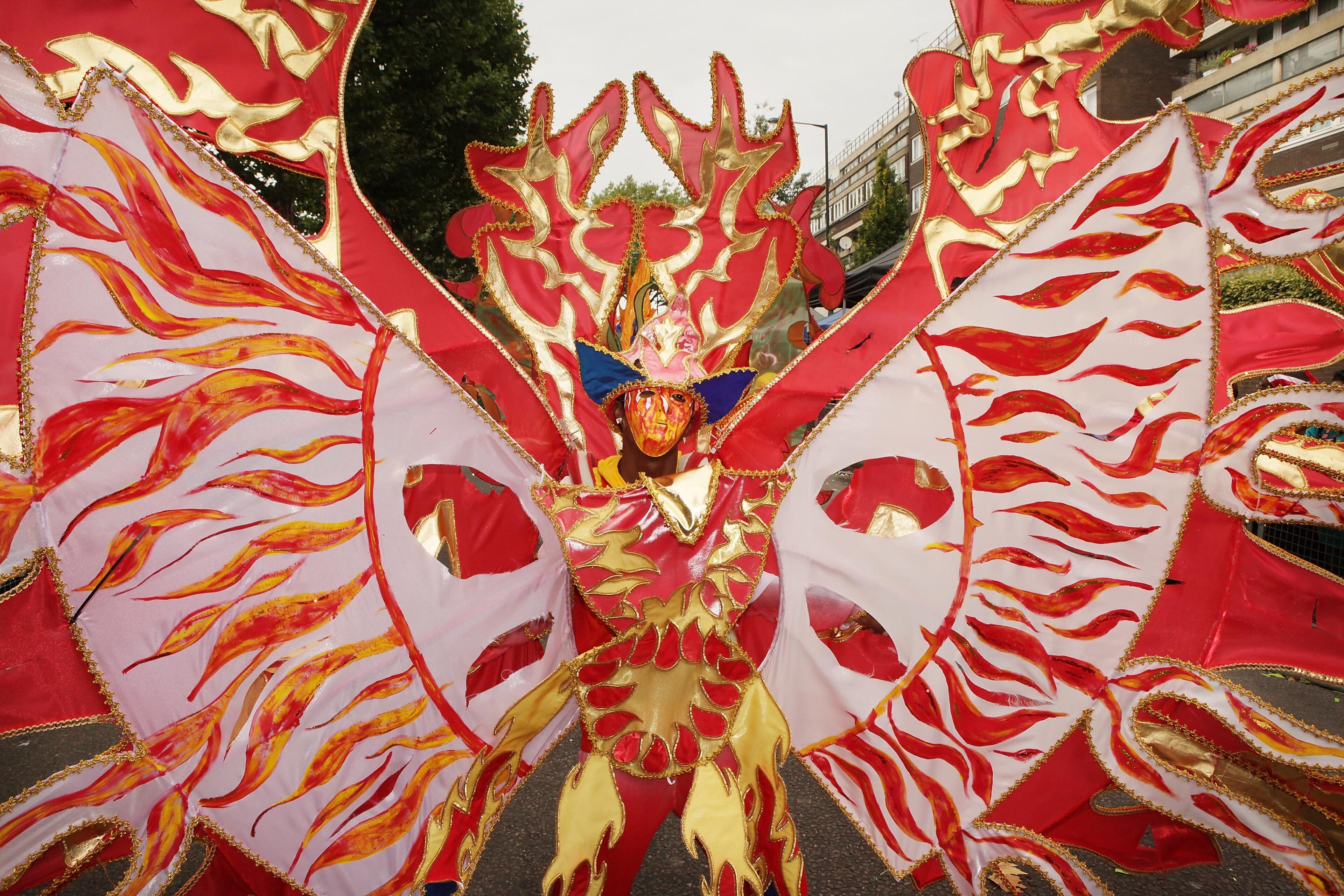LONDON, ENGLAND - AUGUST 31: A dancer takes part in the street procession at the Notting Hill Carnival on August 31, 2009 in London, England. Hundreds of thousands of people are attending Europe's biggest street party. Carnival floats, dancers, food stalls and 40 static sound systems entertain revellers on the 3.5 mile route through the streets of west London. (Photo by Peter Macdiarmid/Getty Images)
