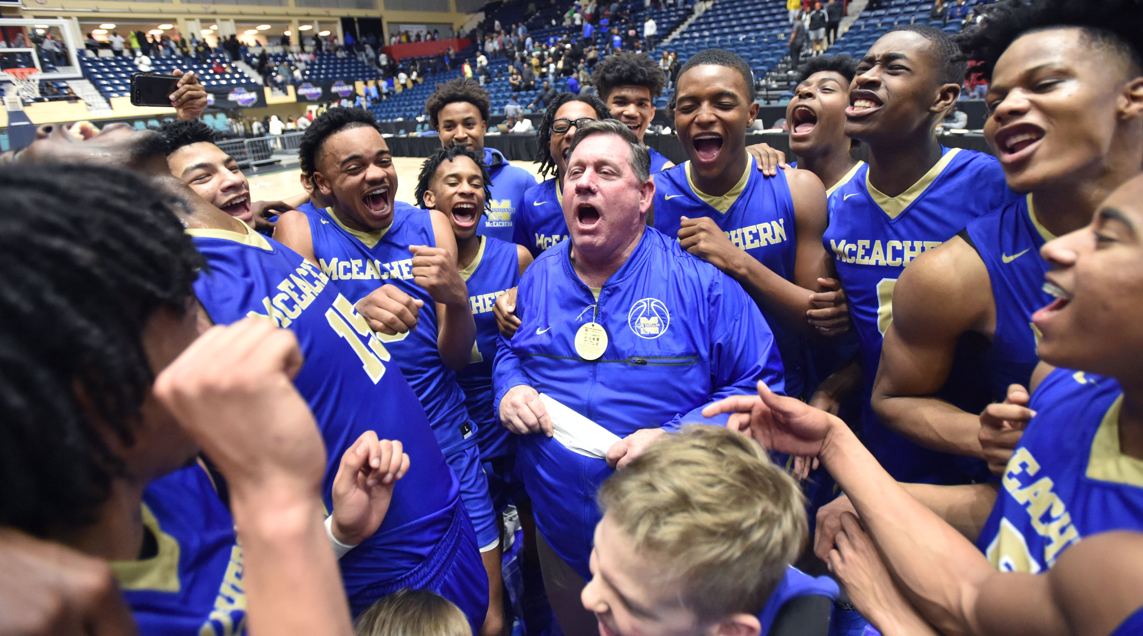 March 9, 2019 Macon - McEachern head coach Mike Thompson and players celebrate their victory over the Meadowcreek in GHSA State Basketball Championship game at the Macon Centreplex in Macon on Saturday, March 9, 2019. McEachern won 62-54 over the Meadowcreek. HYOSUB SHIN / HSHIN@AJC.COM