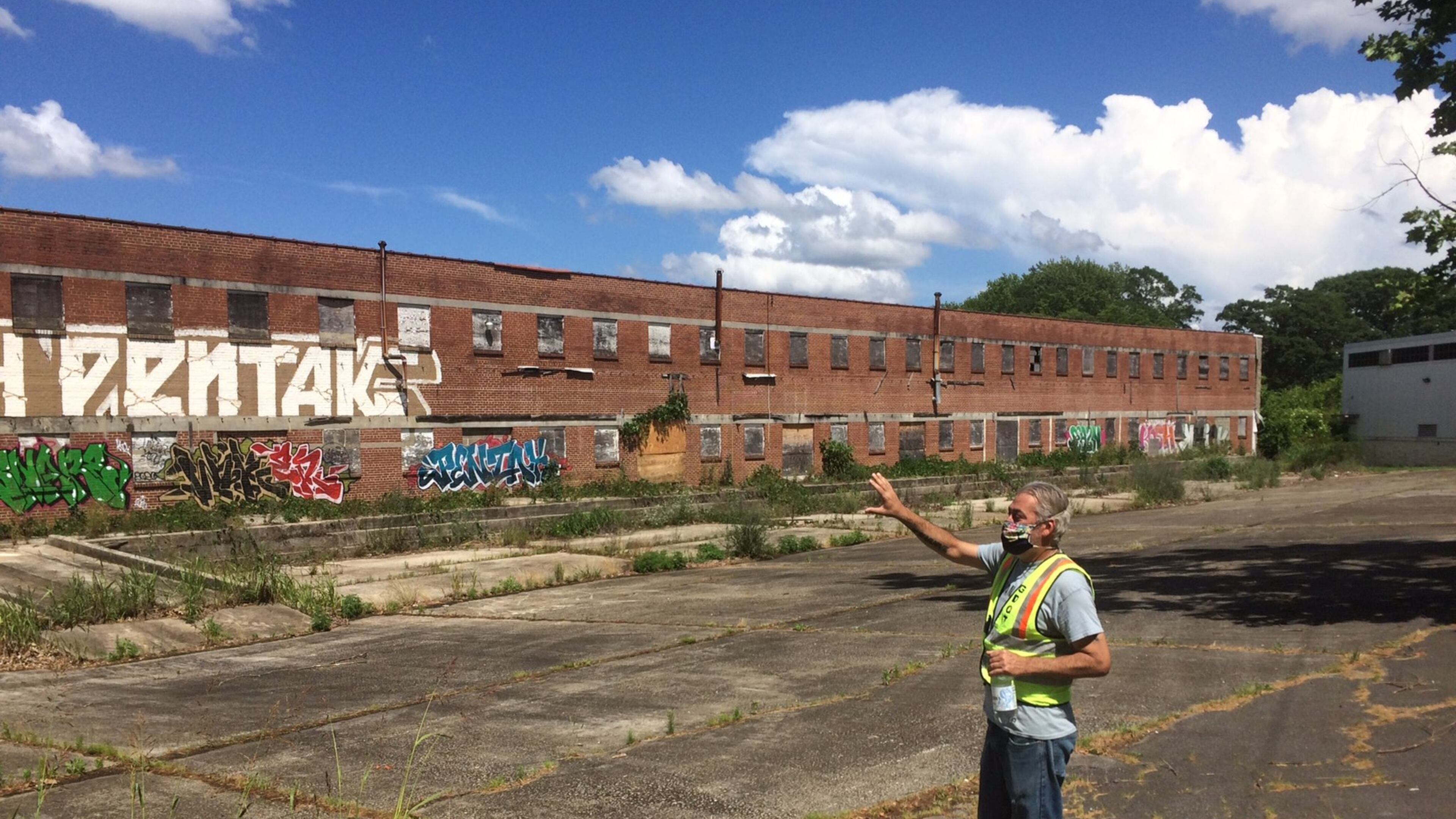 Southwest Atlanta resident Matt Garbett points out an old canning factory in the abandoned 20-acre parcel of old brick industrial buildings called Murphy Crossing. (Photo by Bill Torpy)