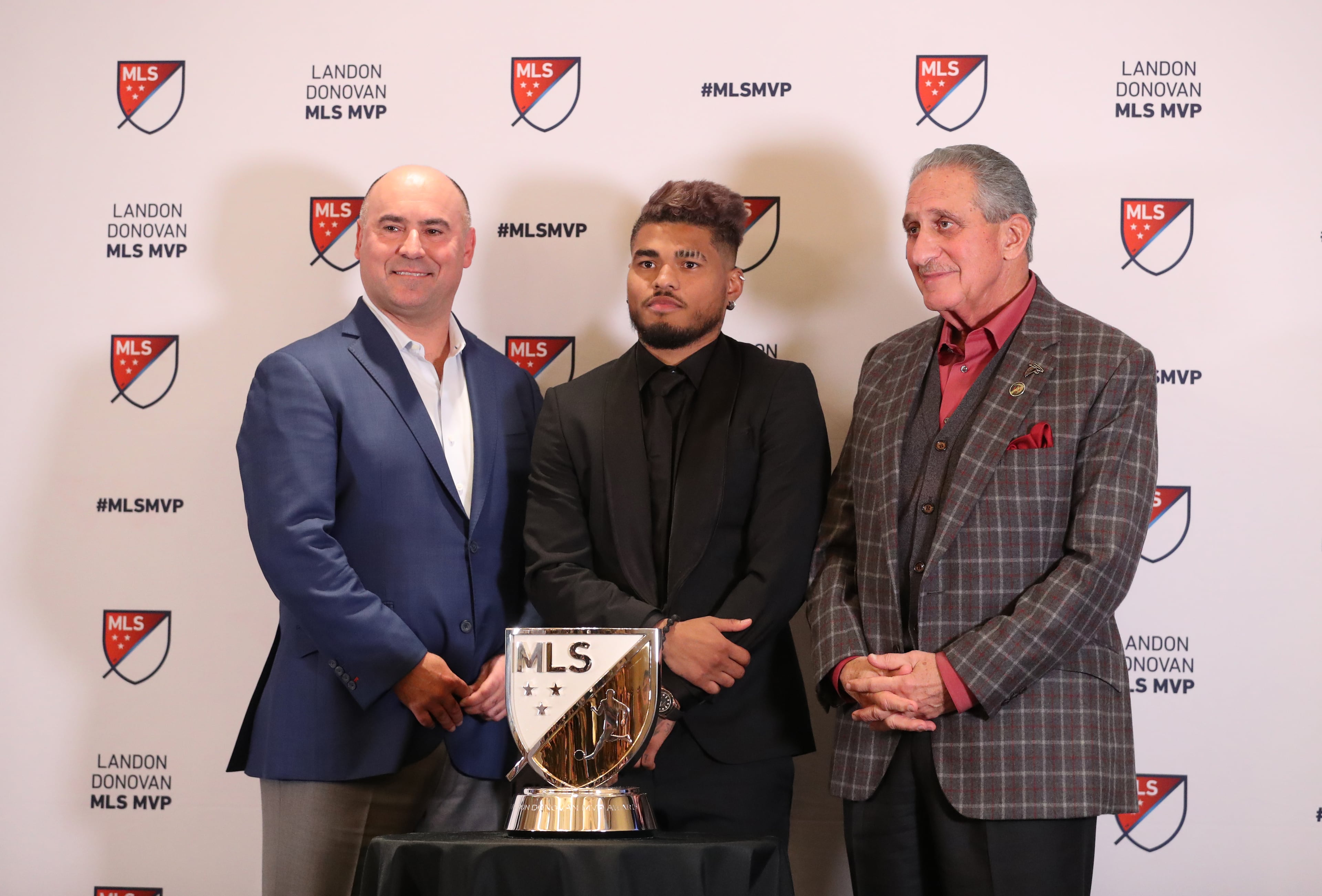 December 5, 2018 - Atlanta, Ga: Atlanta United forward Josef Martinez, center, stands next to Lino DiCuollo, MLS SVP of Player Relations & Competition, left, and Arthur Blank, Atlanta United Owner, as he receives the MLS MVP at the Arthur M. Blank Family Office Wednesday, December 5, 2018, in Atlanta. (JASON GETZ/SPECIAL TO THE AJC)