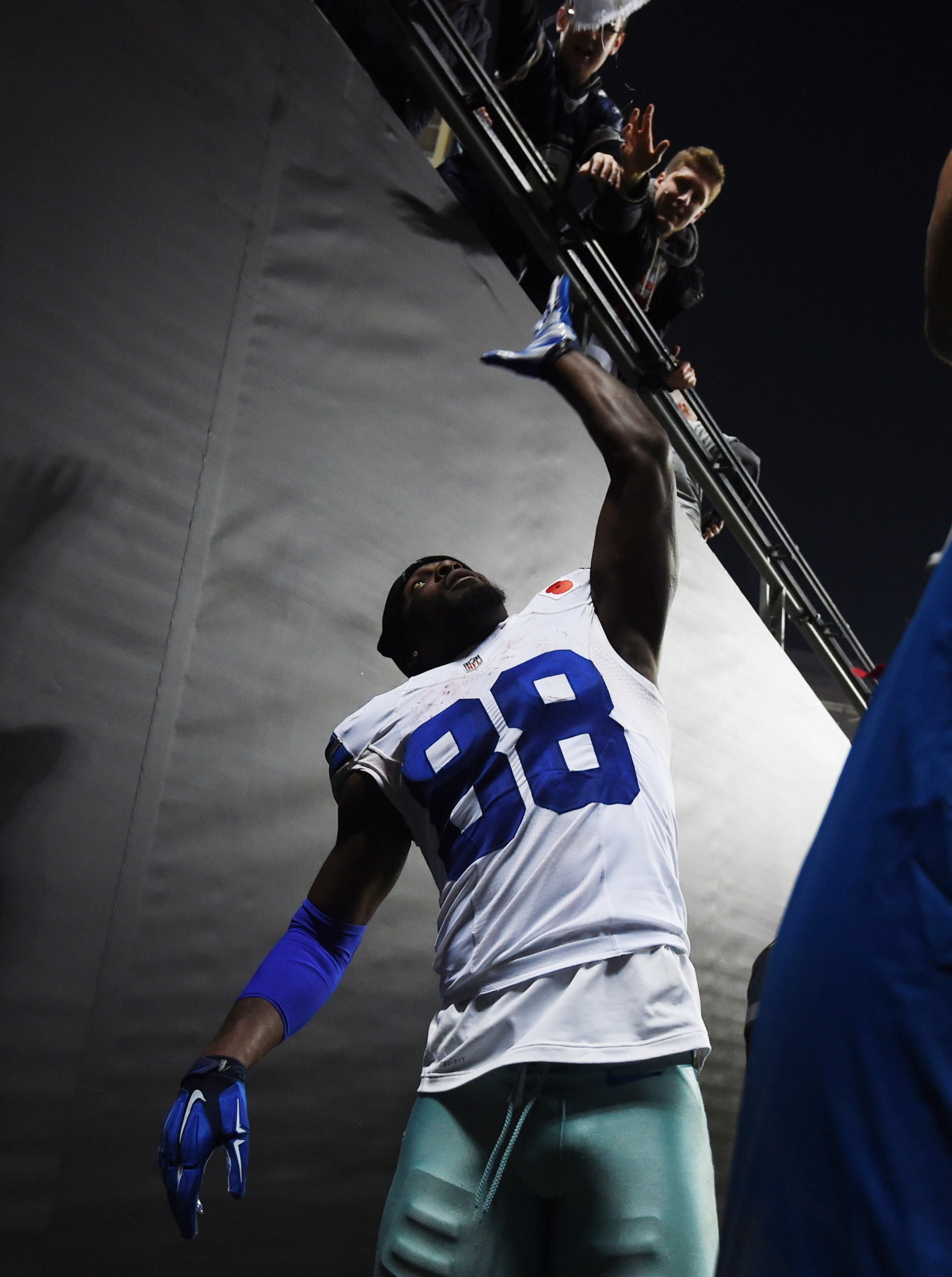Dallas Cowboys wide receiver Dez Bryant waves to spectators following the NFL football game against the Jacksonville Jaguars at Wembley Stadium, London, Sunday, Nov. 9, 2014. The Cowboys defeated the Jaguars 31-17. (AP Photo/Tim Ireland)