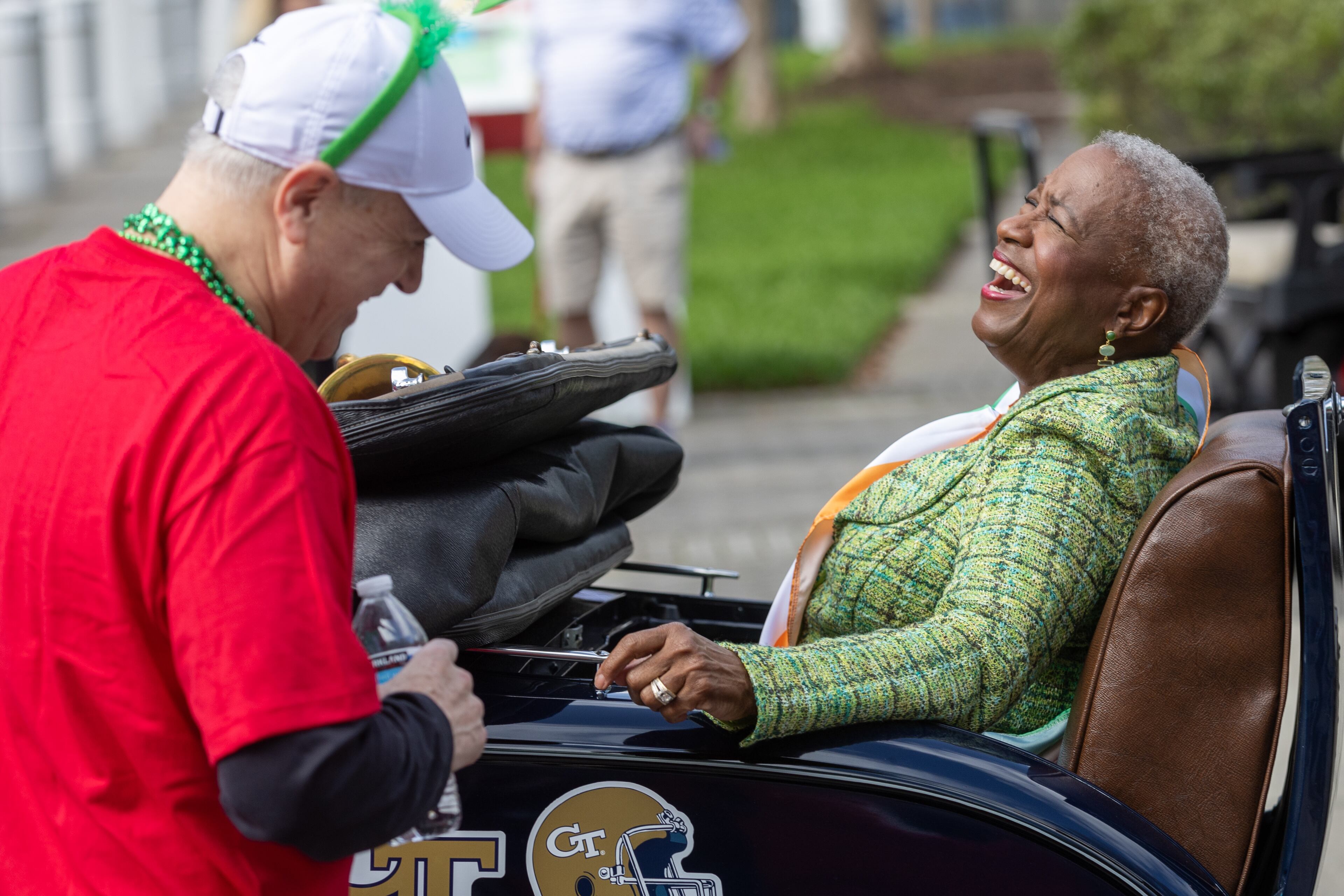 Monica Pearson, this year's grand marshal, sits in a Vintage Model A car and talks with people before the 140th Annual Atlanta St. Patrick’s Parade starts on Saturday, March 16, 2024. (Steve Schaefer/steve.schaefer@ajc.com)
