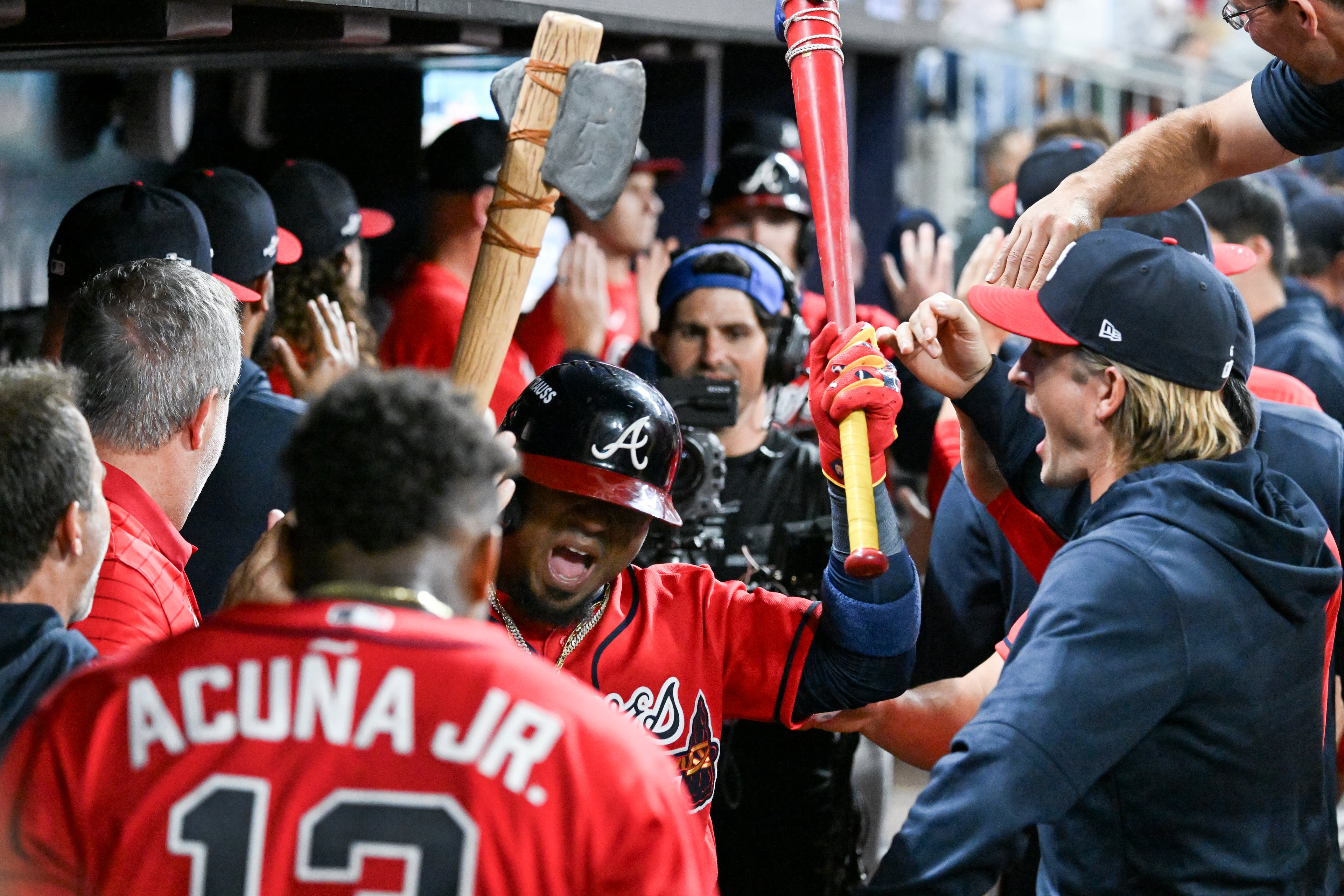 Braves second baseman Ozzie Albies (center) celebrates in the dugout with teammates after hitting a two-run home run against the Phillies during Game 3 of their NL Wild Card Series on Thursday, Oct. 1, 2026, in Atlanta. (Hyosub Shin/AJC)