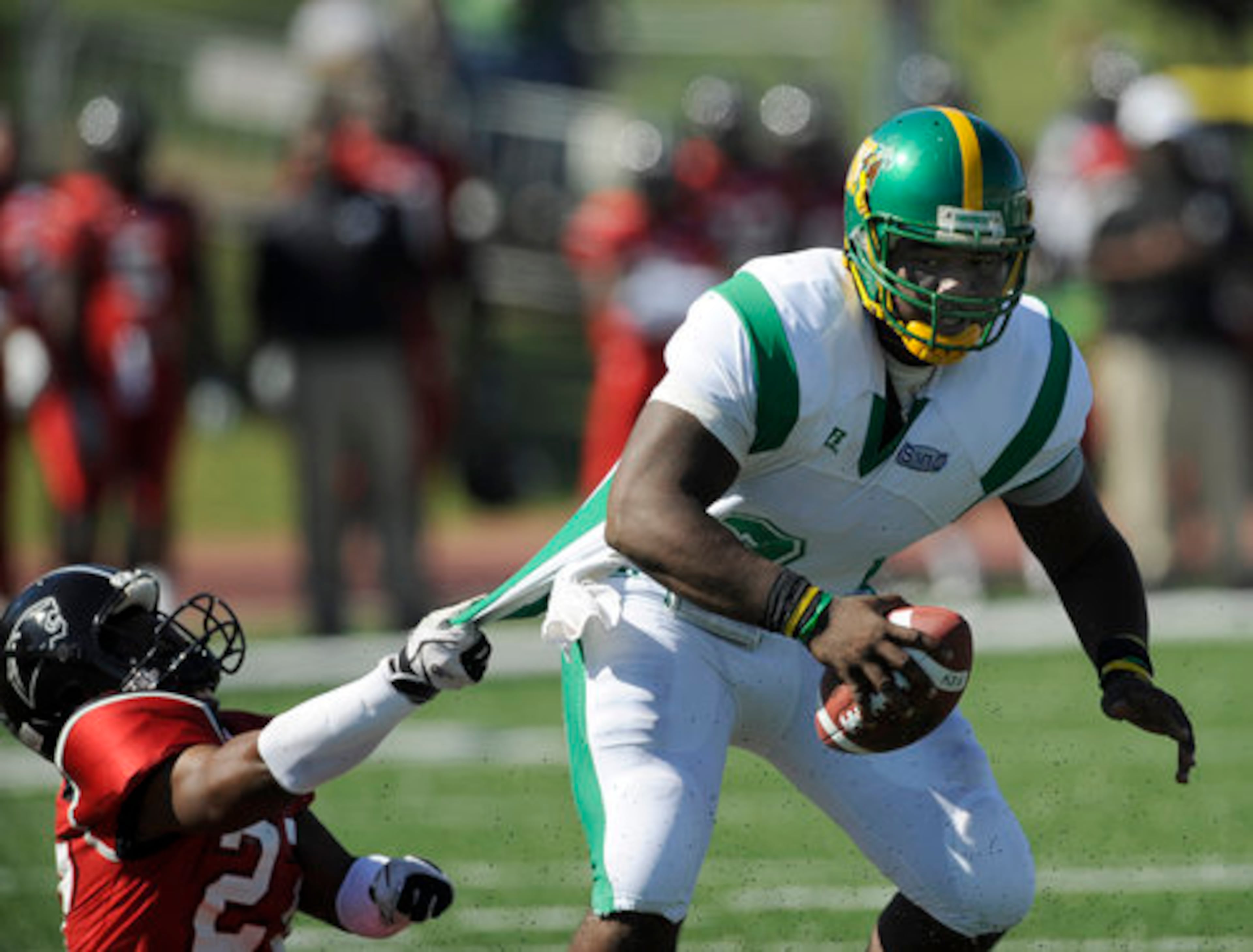 Clark Atlanta's Dominic Hughes tries to keep Kentucky State QB Jerrell Noland from breaking away during a third-quarter play.