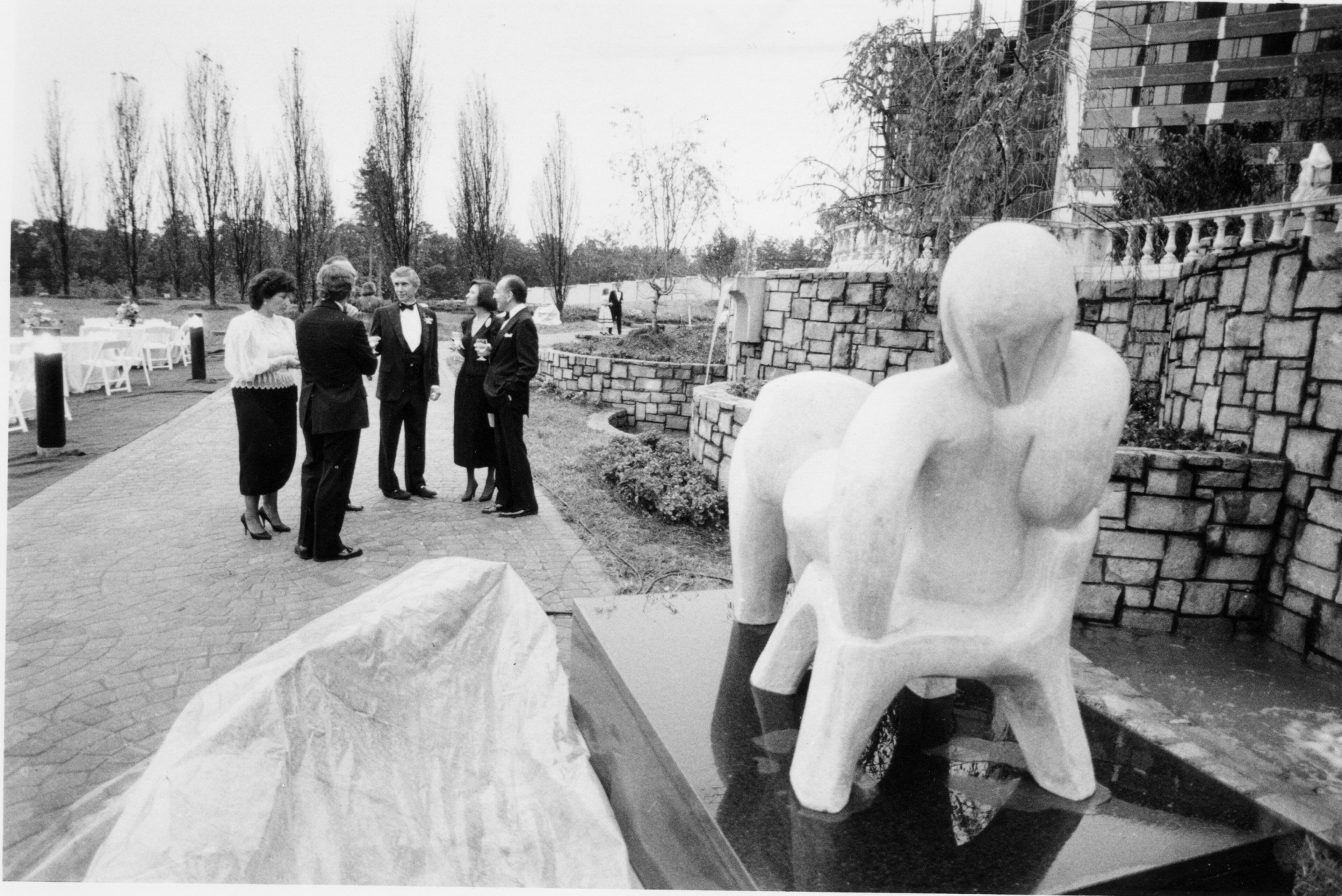 850816 - Atlanta, Ga: - OPENING OF CROWN POINTE OFFICE PARK - Guests at the party given by Charles Ackerman (third from right) included Mr. and Mrs. Edward E. Elson (right). In the foreground is 'Reclining Figure' by Elena Laveron.