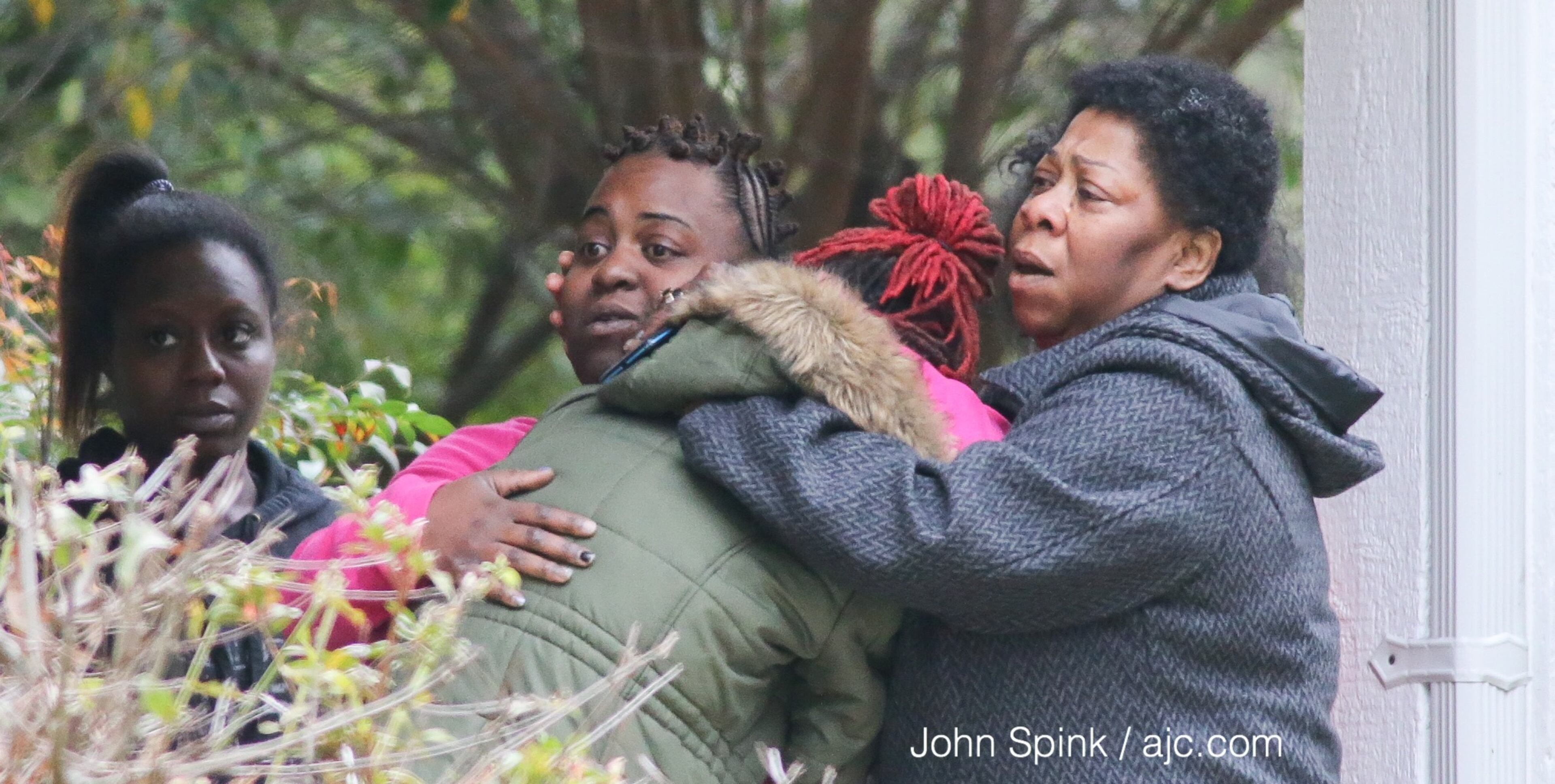 Family and friends console one another at the residence where two Clayton county girls went missing. They were later found down the street. JOHN SPINK / JSPINK@AJC.COM