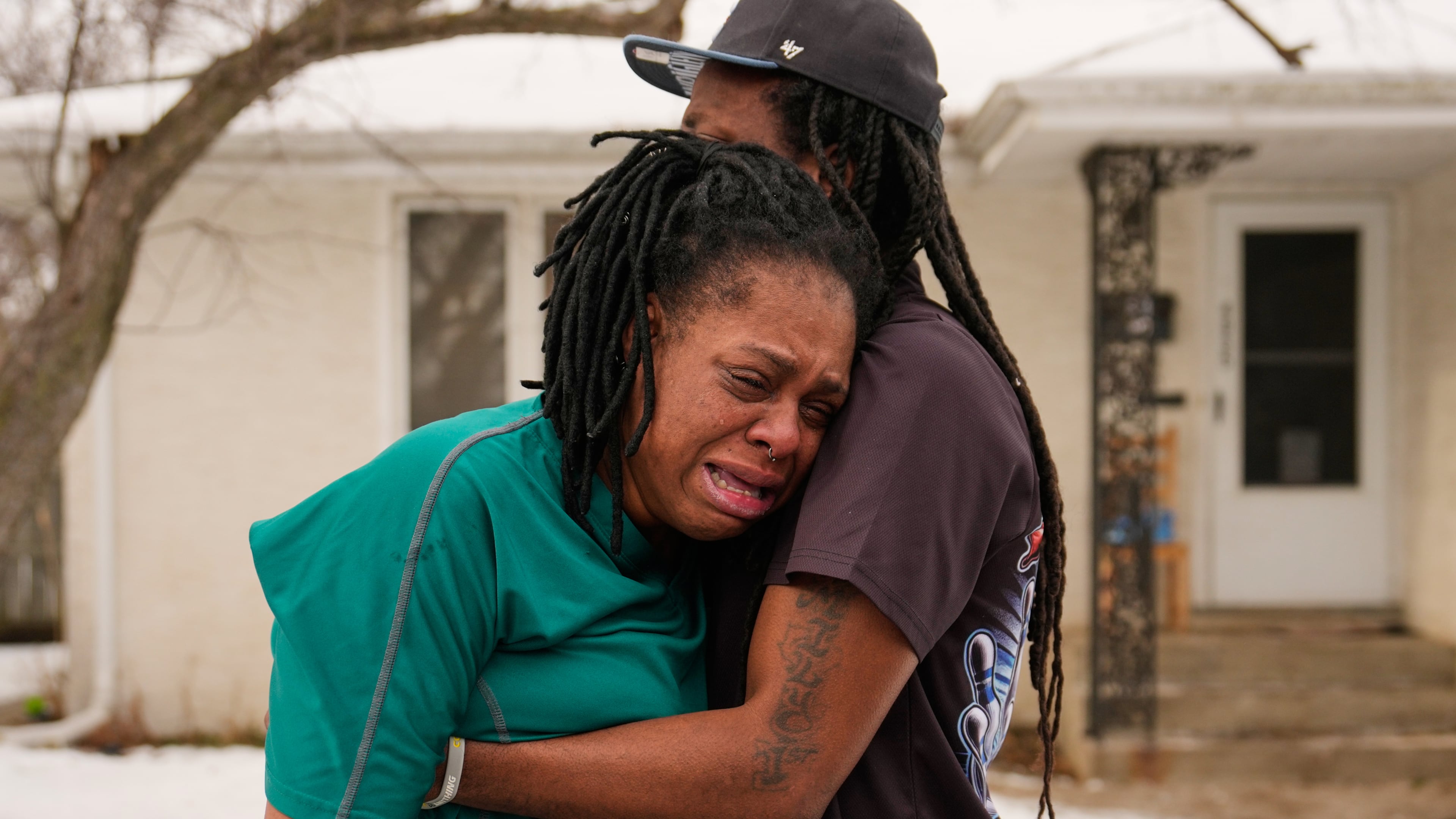 A family member reacts after federal immigration officers make an arrest Sunday, Jan. 11, 2026, in Minneapolis. (AP Photo/John Locher)