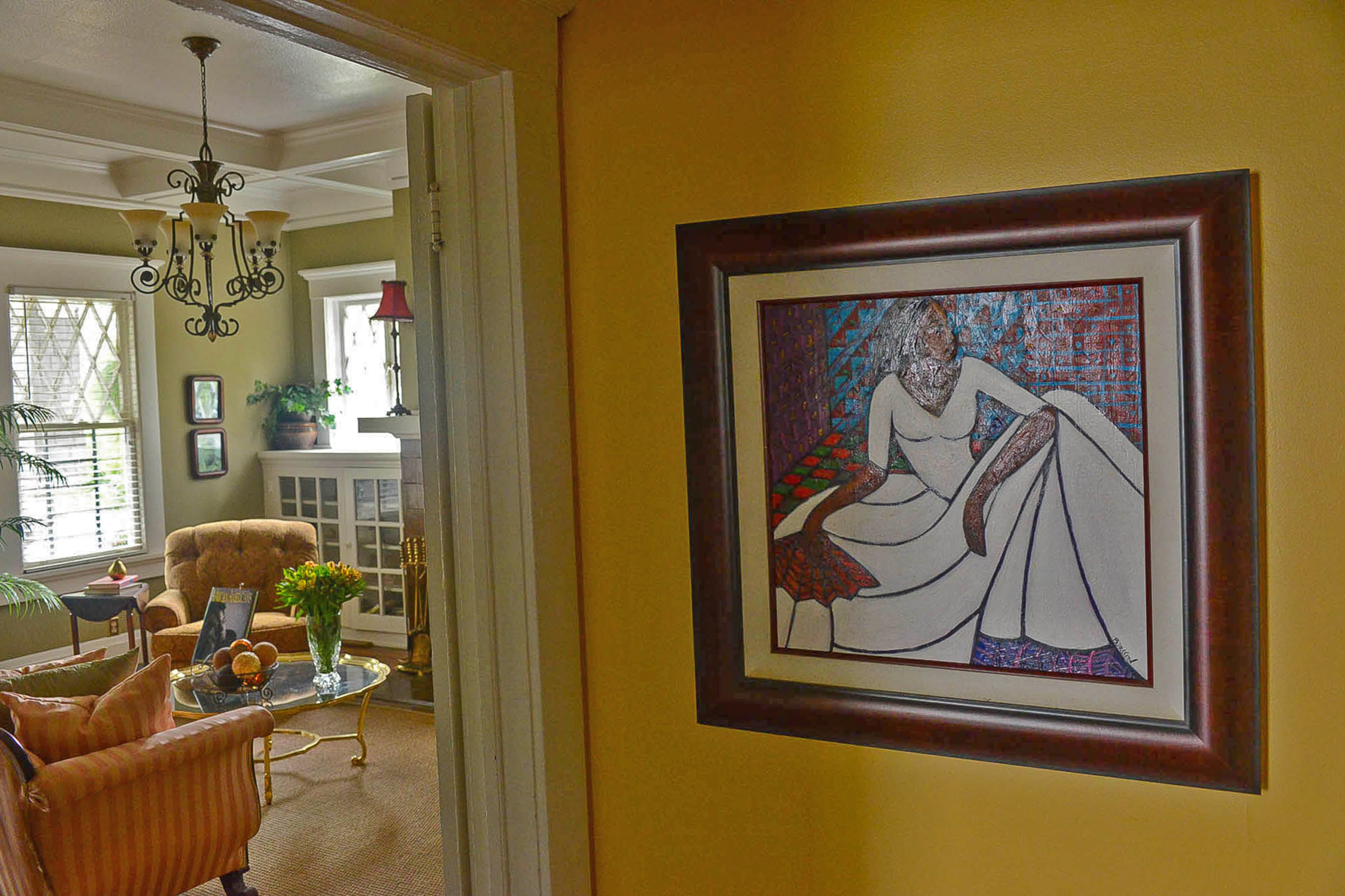 Throughout the bungalow, African-American art is on display, including a painting of a woman by Atlantan Sam D. Burston.
