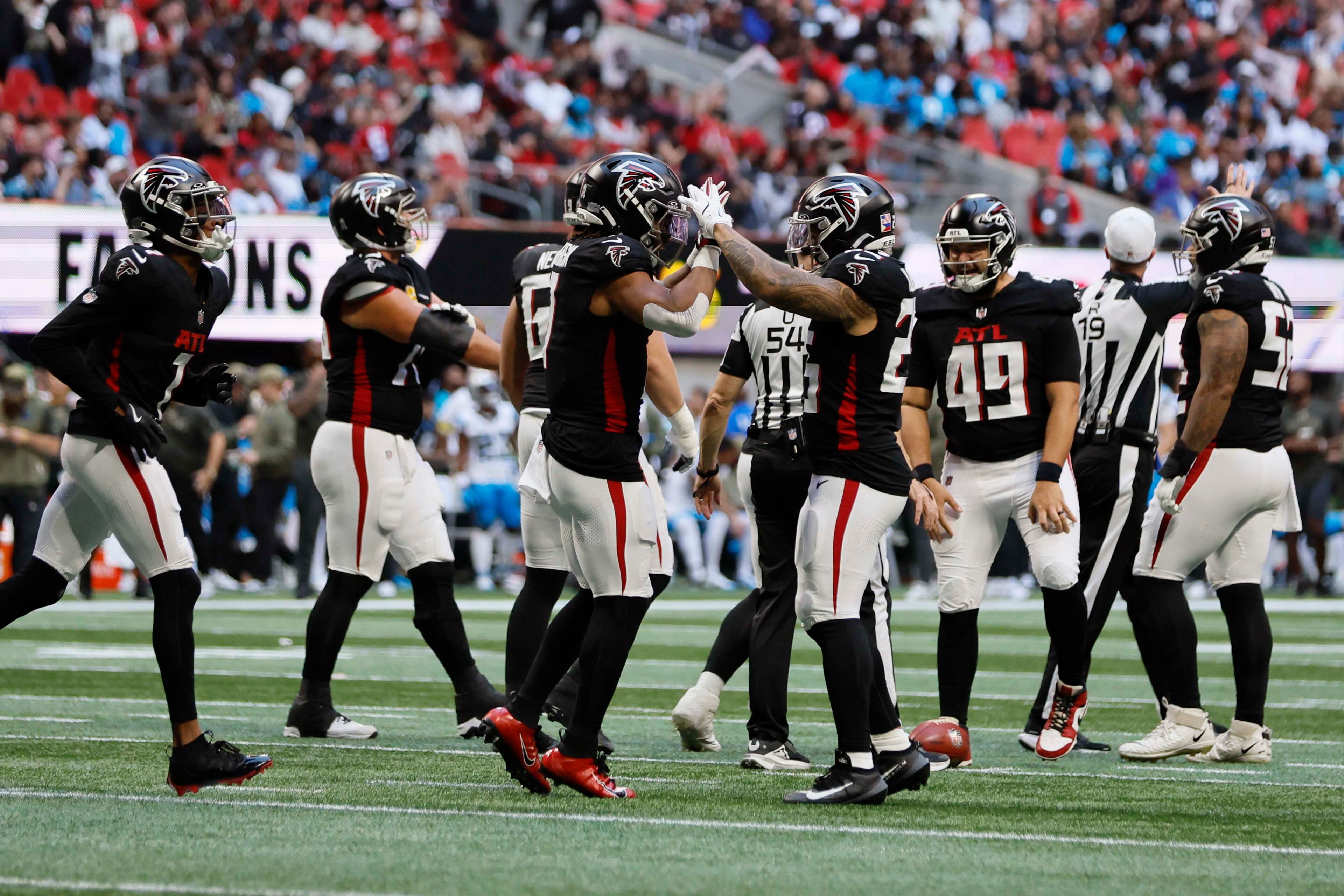 Atlanta Falcons players celebrate with running back Bijan Robinson after he gets a first down during the first half of an NFL game against the Carolina Panthers at Mercedes-Benz Stadium in Atlanta on Sunday, Nov. 16, 2025. (Miguel Martinez/AJC)