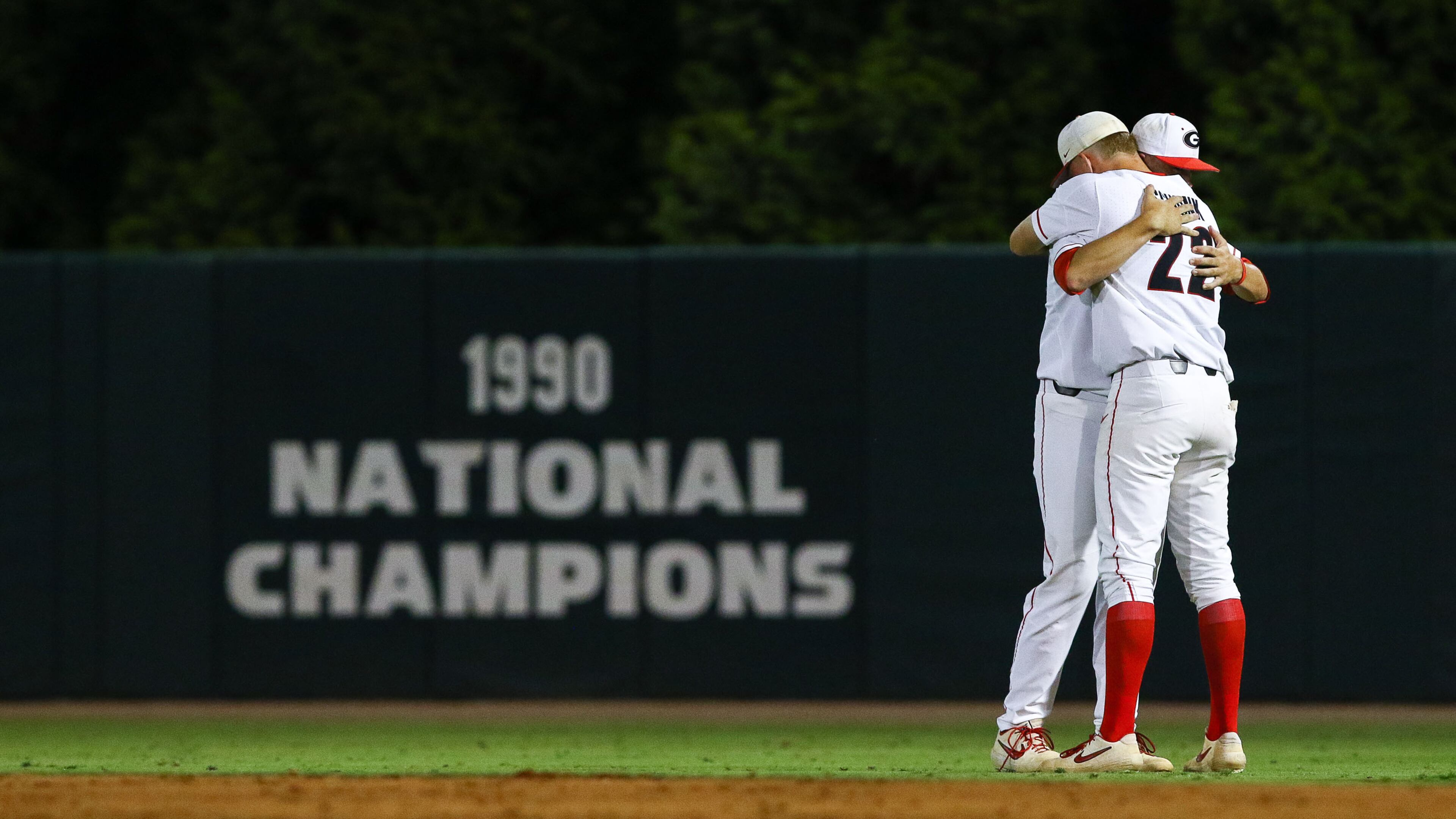 Georgia infielder Aaron Schunk (22) hugs Georgia pitcher James Williams (18) after losing to Florida State in the NCAA regional baseball Sunday, June 2, 2019, in Athens.. Georgia was eliminated after a, 10-1, loss.