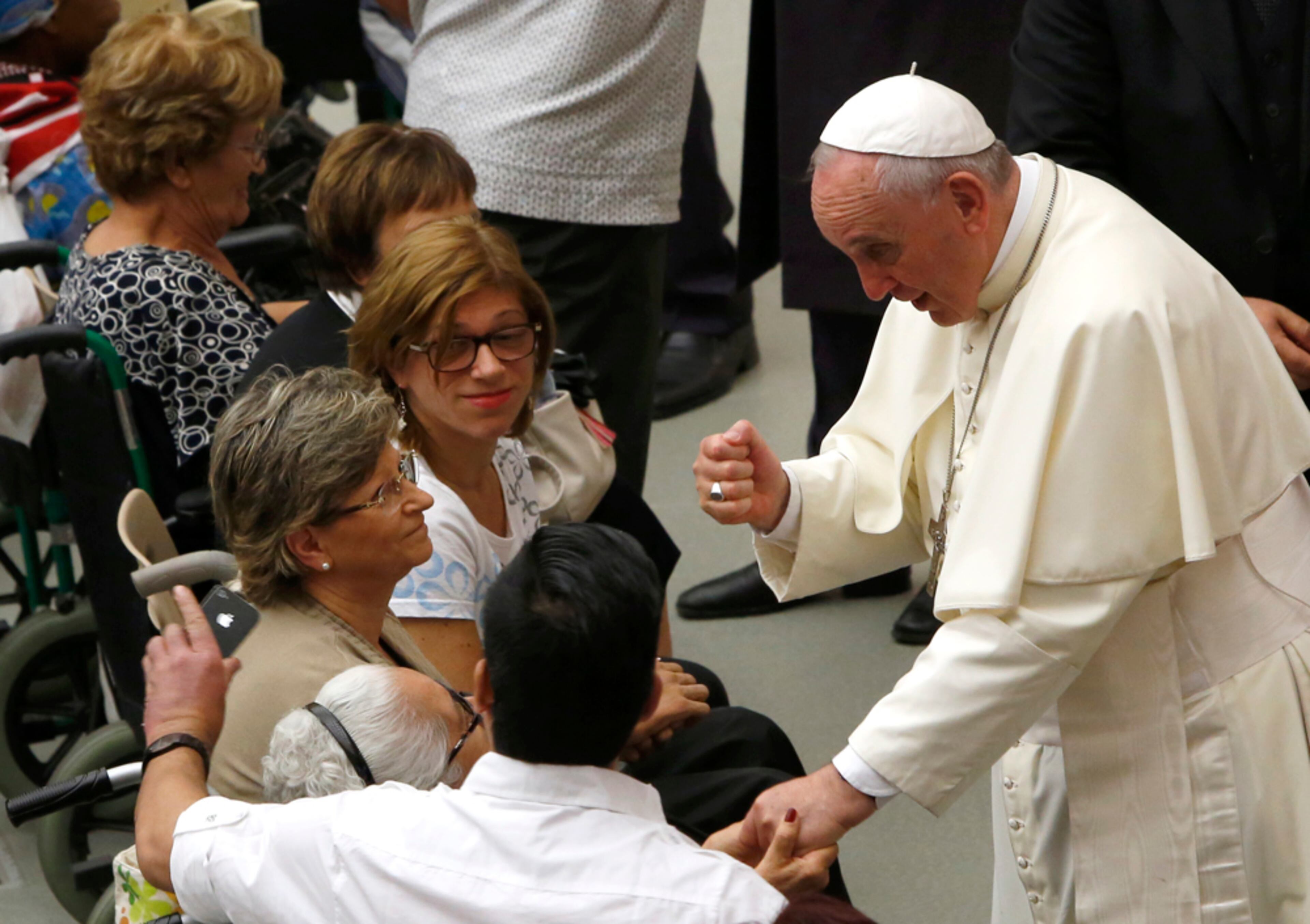 ROCK PAPER SCISSORS?--Pope Francis greets faithful at the end of his weekly general audience in the Paul VI hall, at the Vatican, Wednesday, Aug. 20, 2014. (AP Photo/Riccardo De Luca)