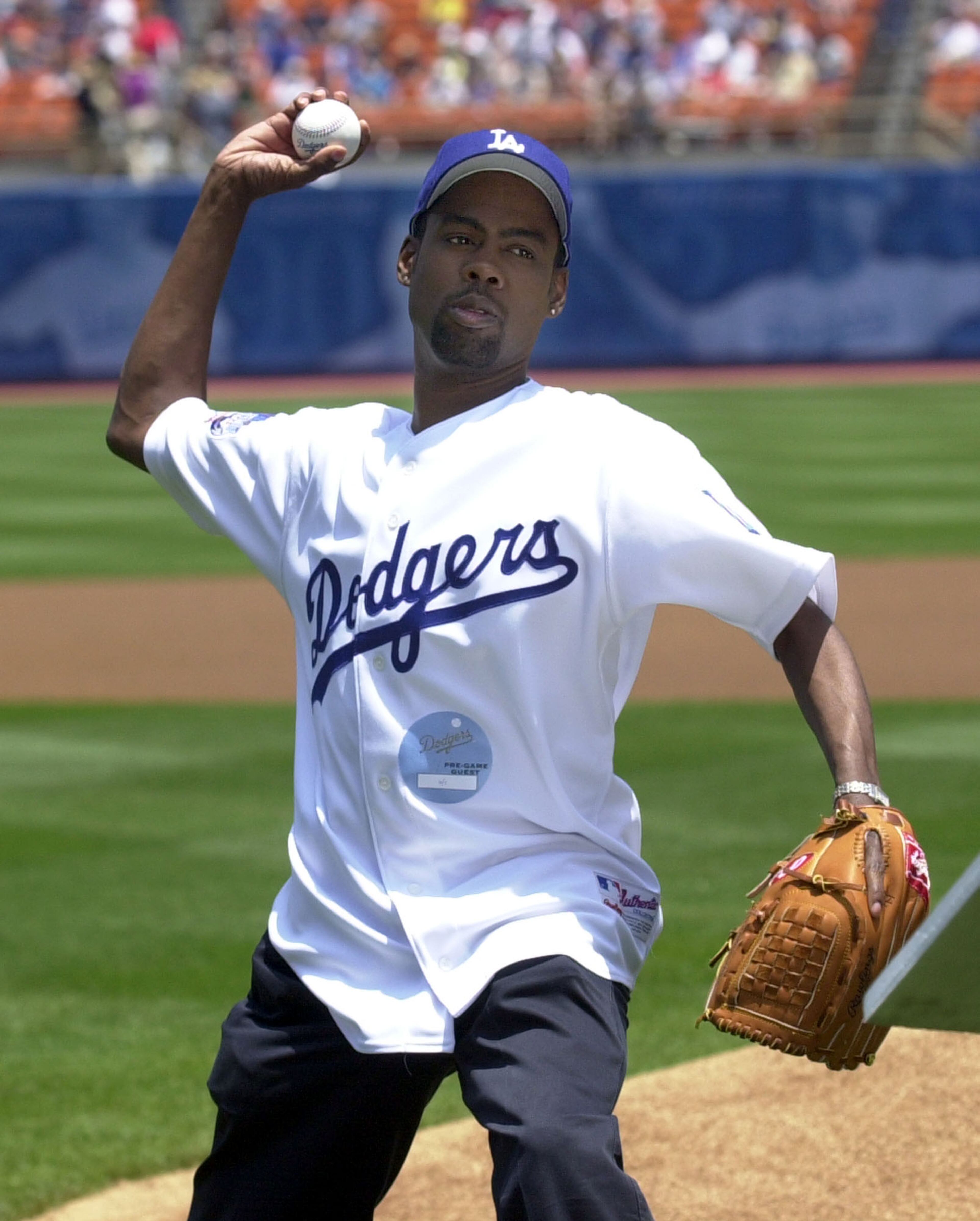 Comedian and actor Chris Rock, right, throws the ceremonial first pitch to open the game between the Los Angeles Dodgers and the Arizona Diamondbacks at Dodger Stadium in Los Angeles, Saturday, June 1, 2002. Rock also read Lou Gehrig's farewell speech to raise awareness about Amyotrophic Lateral Sclerosis (ALS), also known as Lou Gehrig's disease. (AP Photo/Krista Niles)