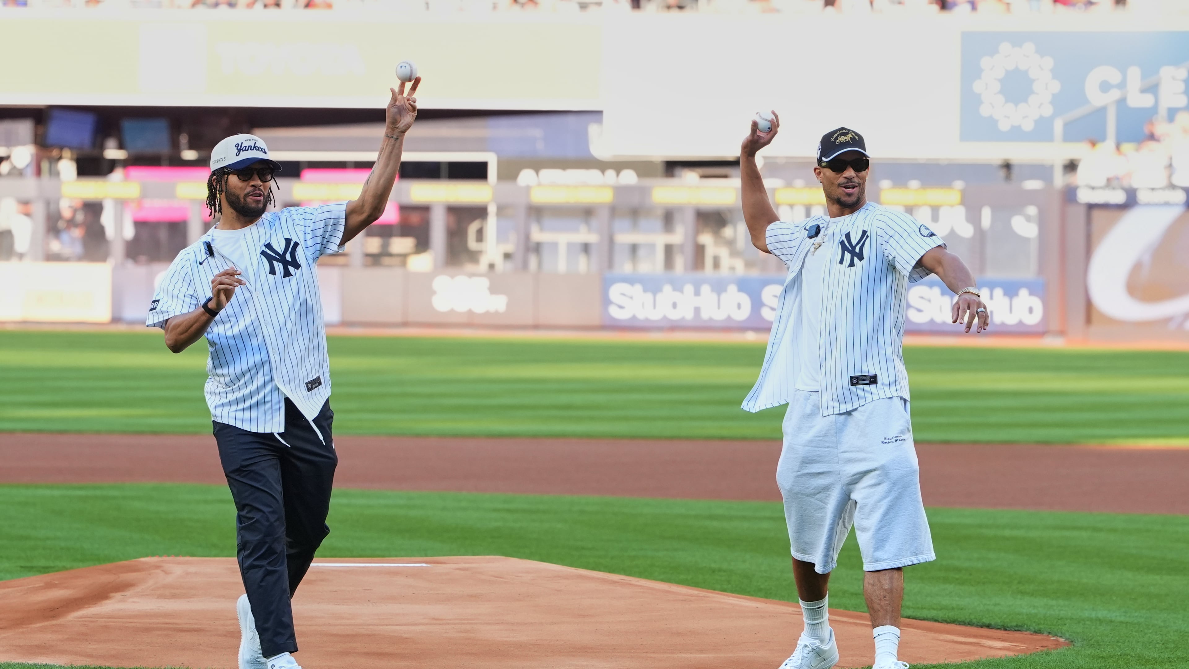 New York Knicks' Josh Hart, right, and Jalen Brunson throw out a ceremonial first pitch before a baseball game between the Chicago White Sox and the New York Yankees Wednesday, June 17, 2026, in New York. (AP Photo/Frank Franklin II)