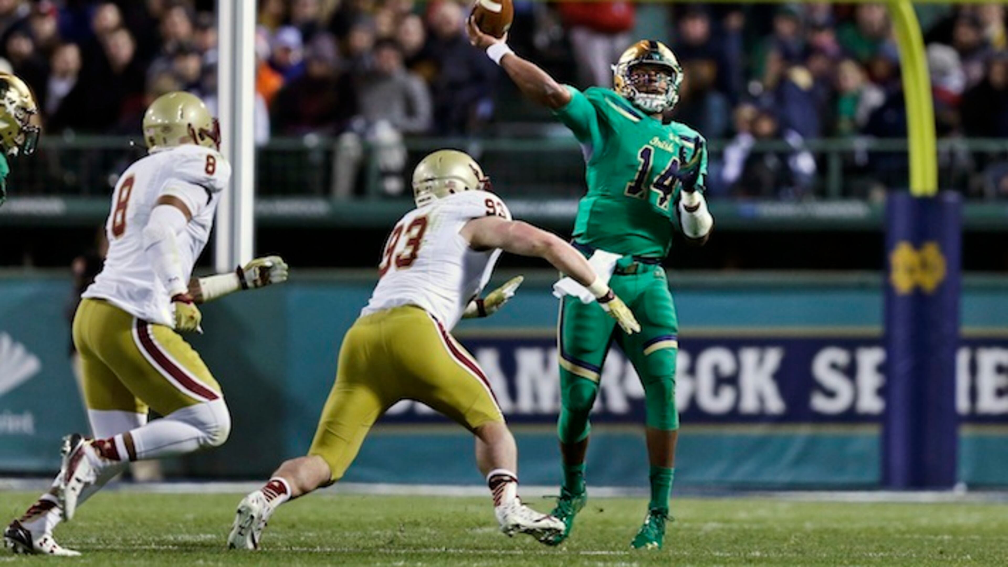 Notre Dame quarterback DeShone Kizer (14) throws a pass as he is pressured by Boston College defensive end Kevin Kavalec (93) and defensive lineman Harold Landry (8) during the first half of the Shamrock Series NCAA college football game at Fenway Park, home of the Boston Red Sox, in Boston Saturday, Nov. 21, 2015. (AP Photo/Charles Krupa)