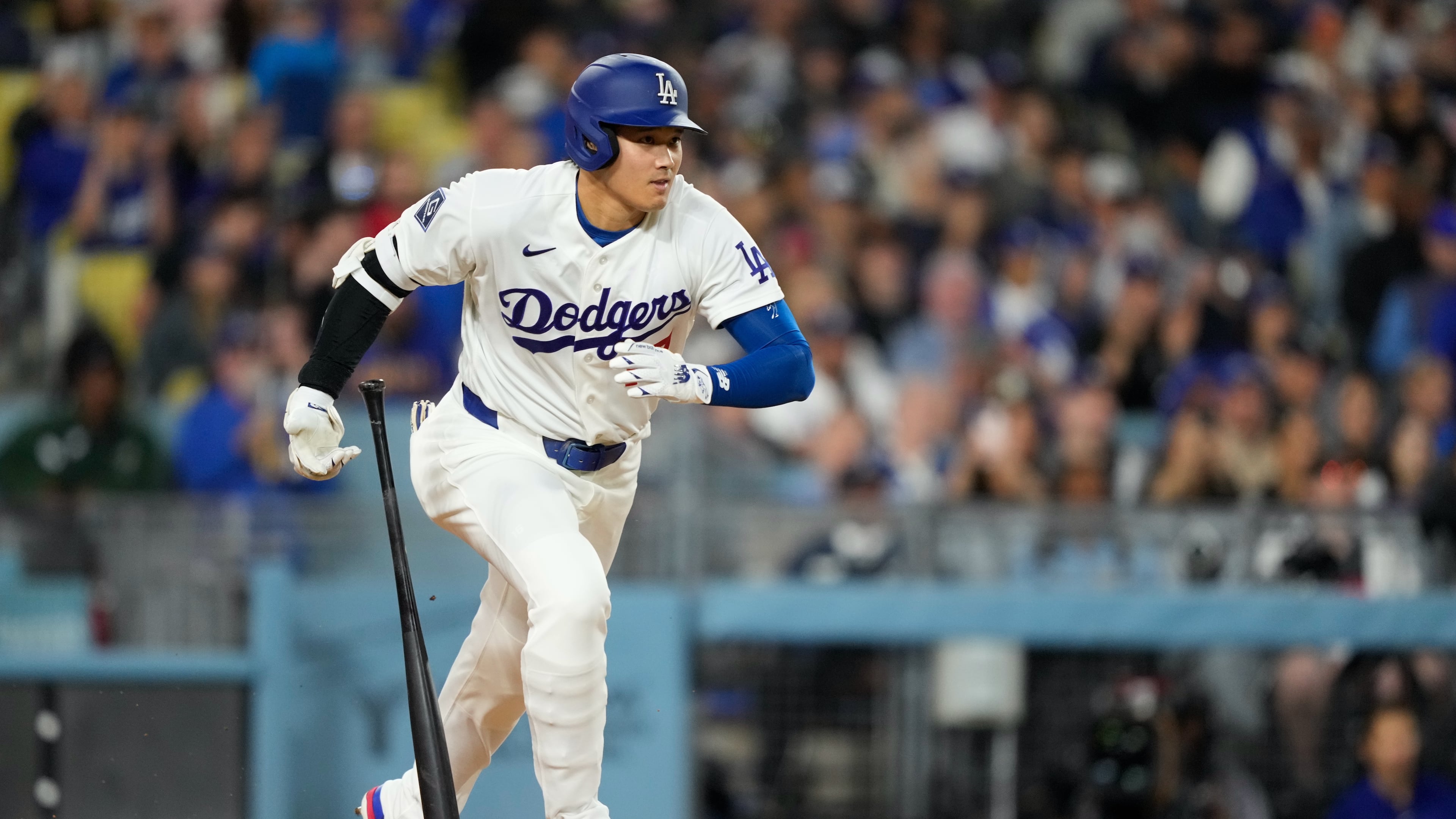 Los Angeles Dodgers' Shohei Ohtani heads to first for a single during the fifth inning of a baseball game against the Texas Rangers, Friday, April 10, 2026, in Los Angeles. (AP Photo/Mark J. Terrill)