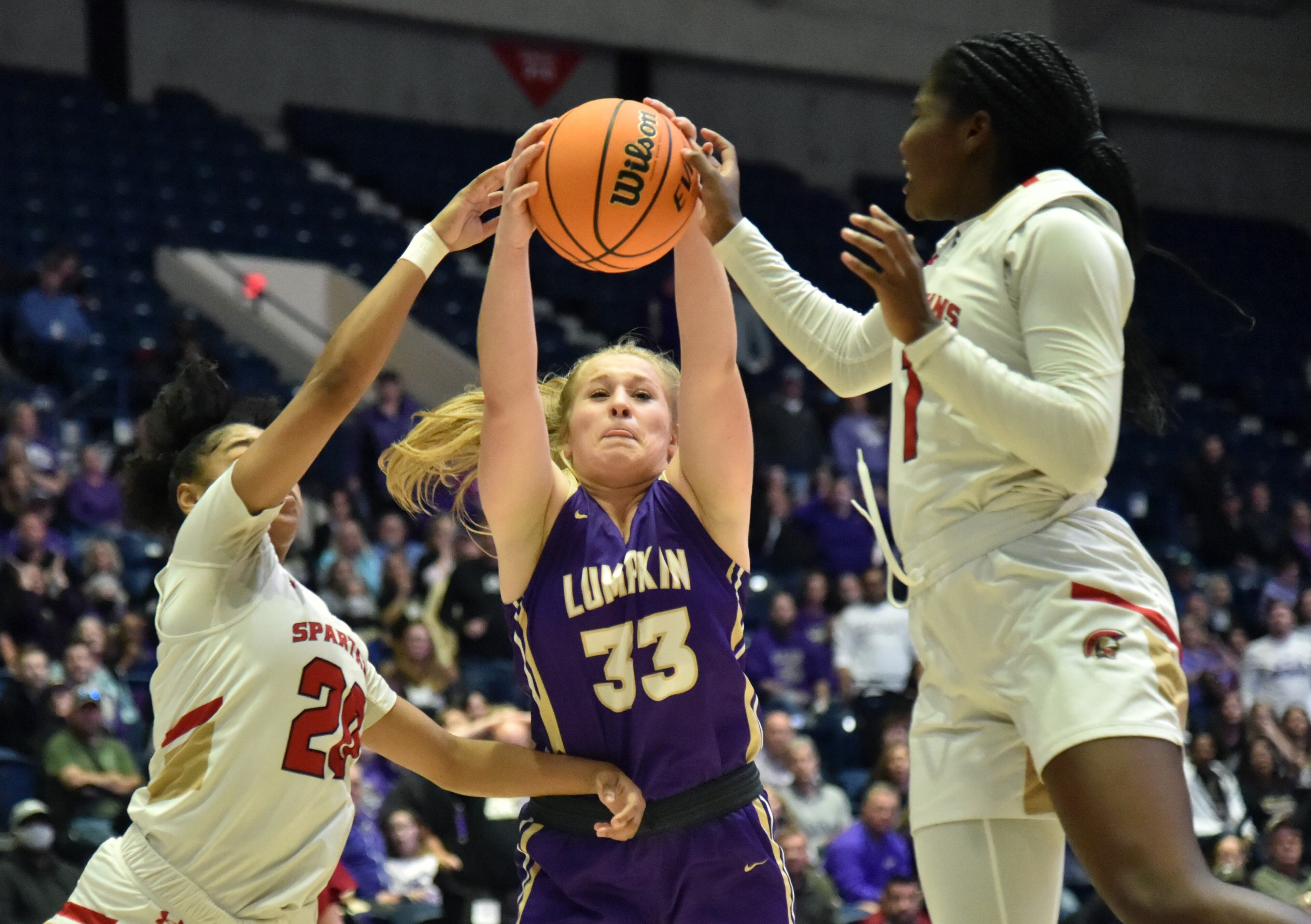 Lumpkin County's Ava Jones (33) grabs a rebound between Greater Atlanta Christian's Autumn Clark (0) and Myla Benton (1) during the 2022 GHSA State Basketball Class AAA Girls Championship game at the Macon Centreplex in Macon on Friday, March 11, 2022. (Hyosub Shin/hshin@ajc.com)