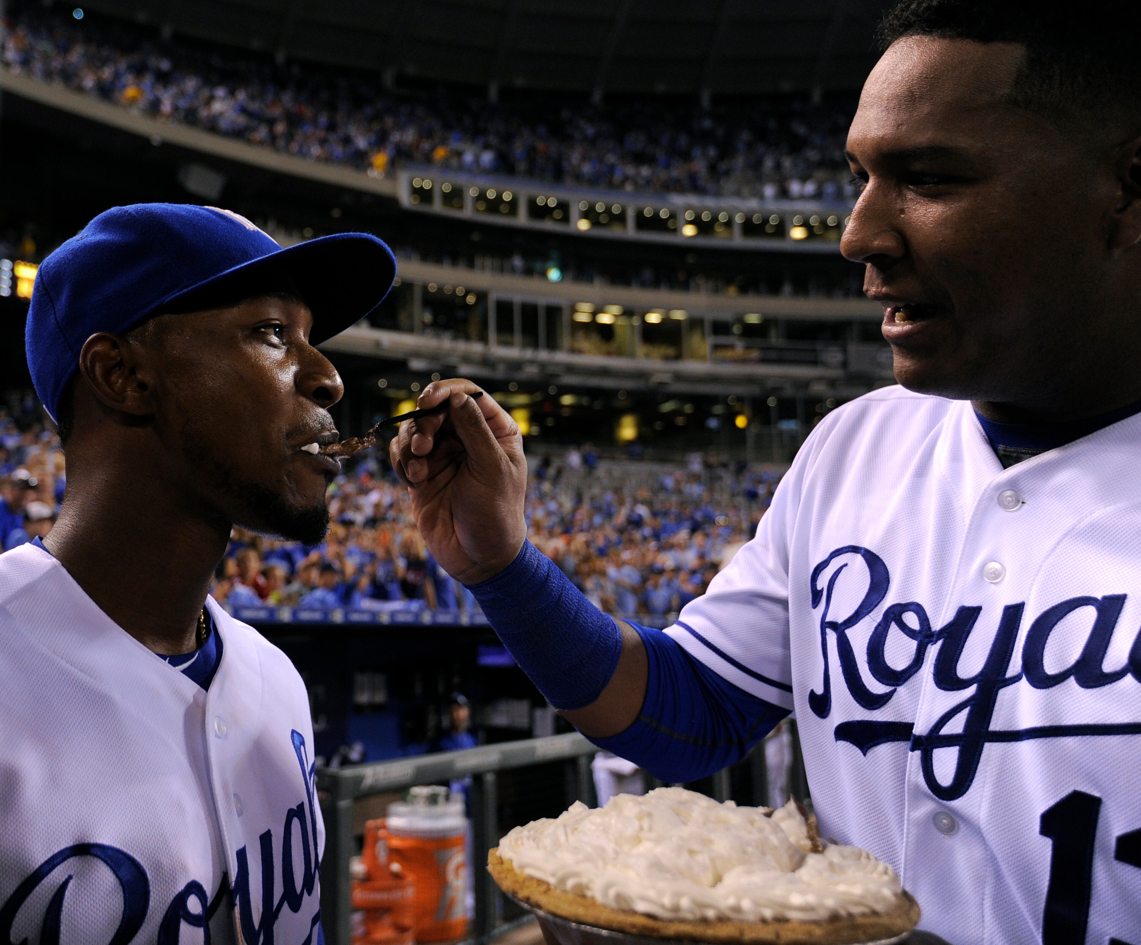 KANSAS CITY, MO - AUGUST 15: Salvador Perez #13 of the Kansas City Royals feeds Jarrod Dyson #1 some pie to celebrate Dyson's 31st birthday and a 9-4 win over the Los Angeles Angels of Anaheim at Kauffman Stadium on August 15, 2015 in Kansas City, Missouri. (Photo by Ed Zurga/Getty Images)