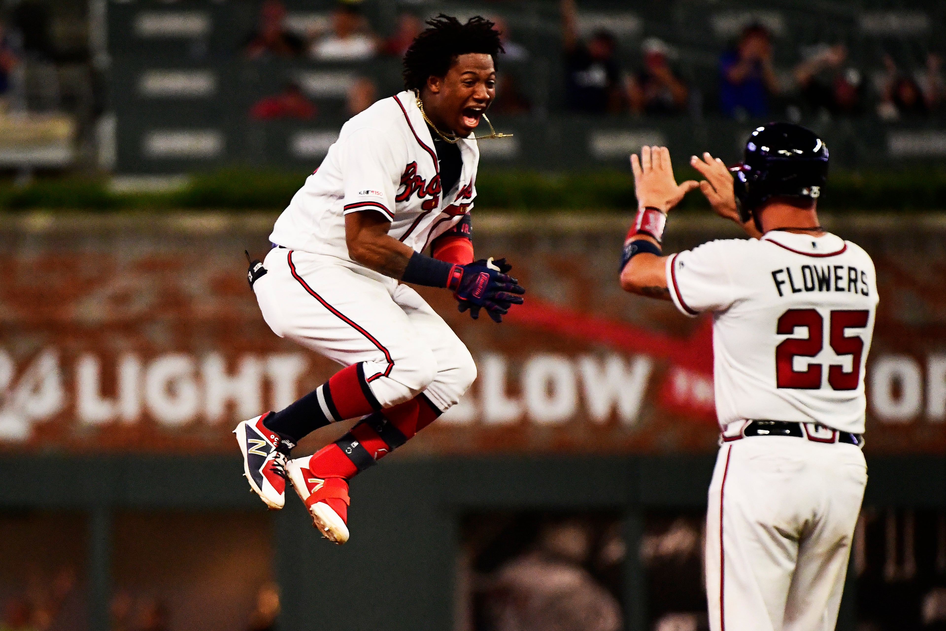 Ronald Acuna Jr. #13 of the Atlanta Braves hits a walk off single in the ninth inning against the Miami Marlins at SunTrust Park on August 22, 2019 in Atlanta, Georgia. (Photo by Logan Riely/Getty Images)