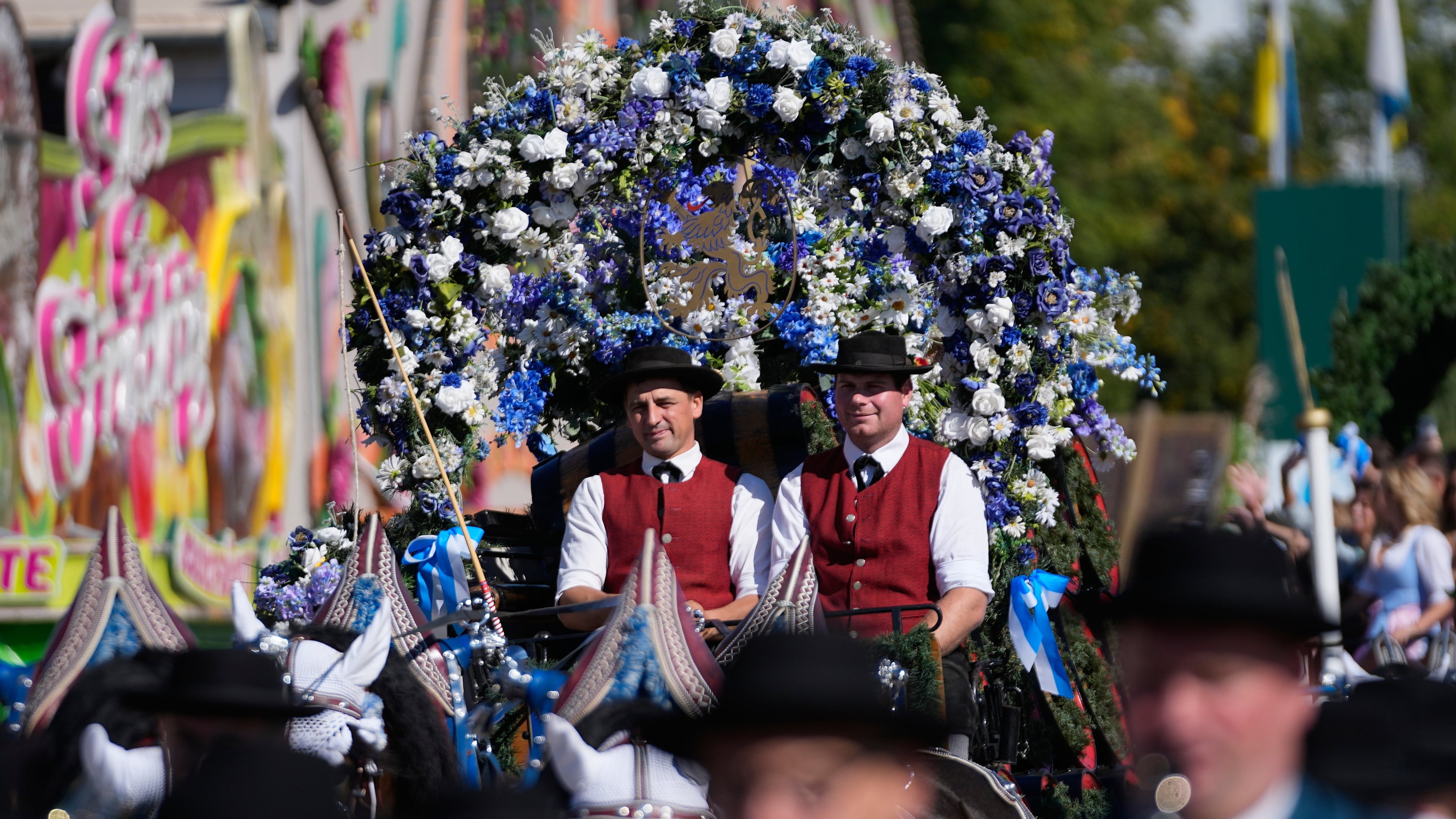 People wear traditional costumes in the Oktoberfest parade at the 191st Oktoberfest beer festival in Munich, Germany, Saturday, Sept.19, 2026. (AP Photo/Matthias Schrader)