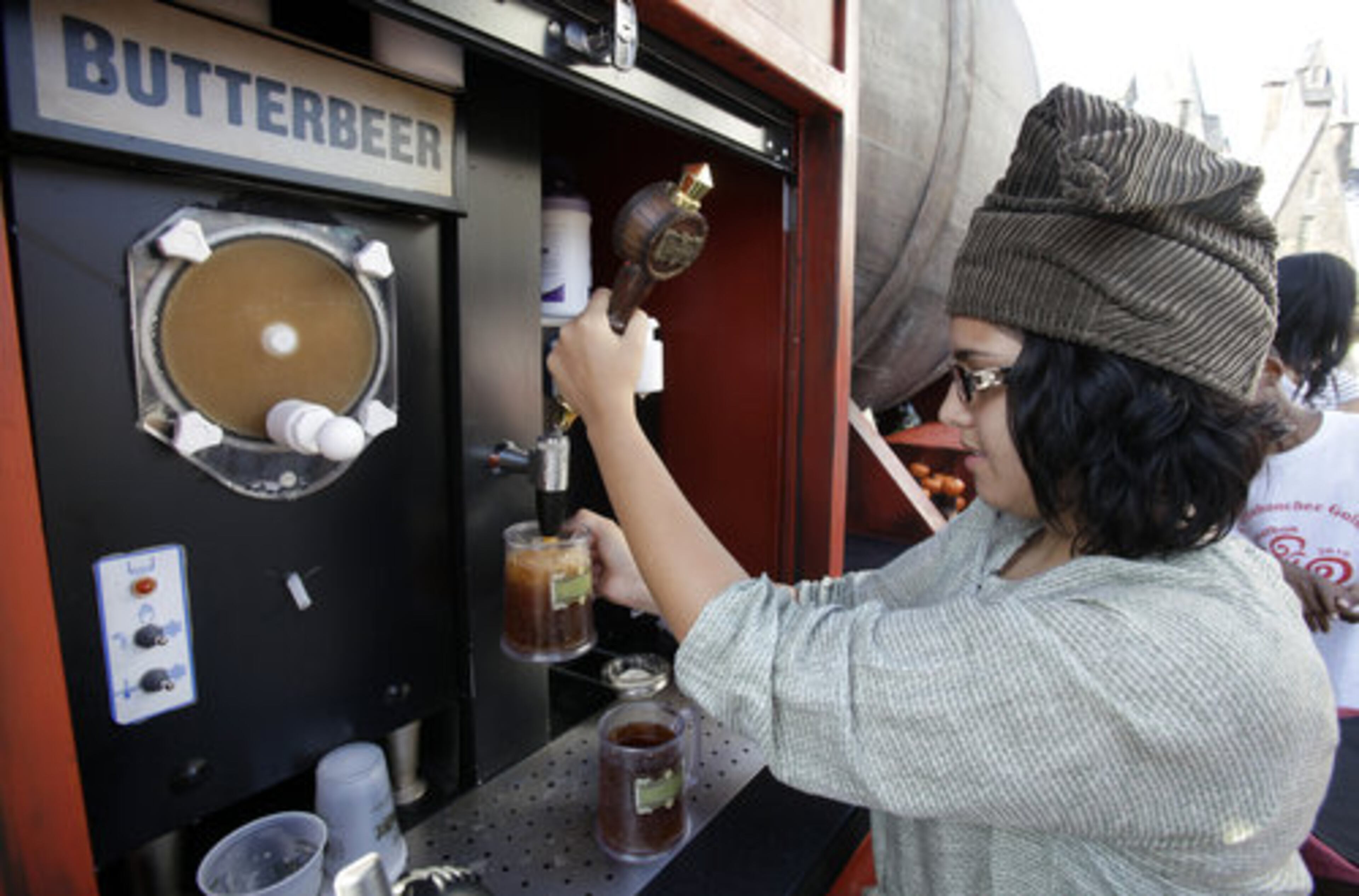 Lisa Dadoush draws a mug of Butterbeer at The Wizarding World of Harry Potter at Universal Orlando theme park in Orlando, Fla.