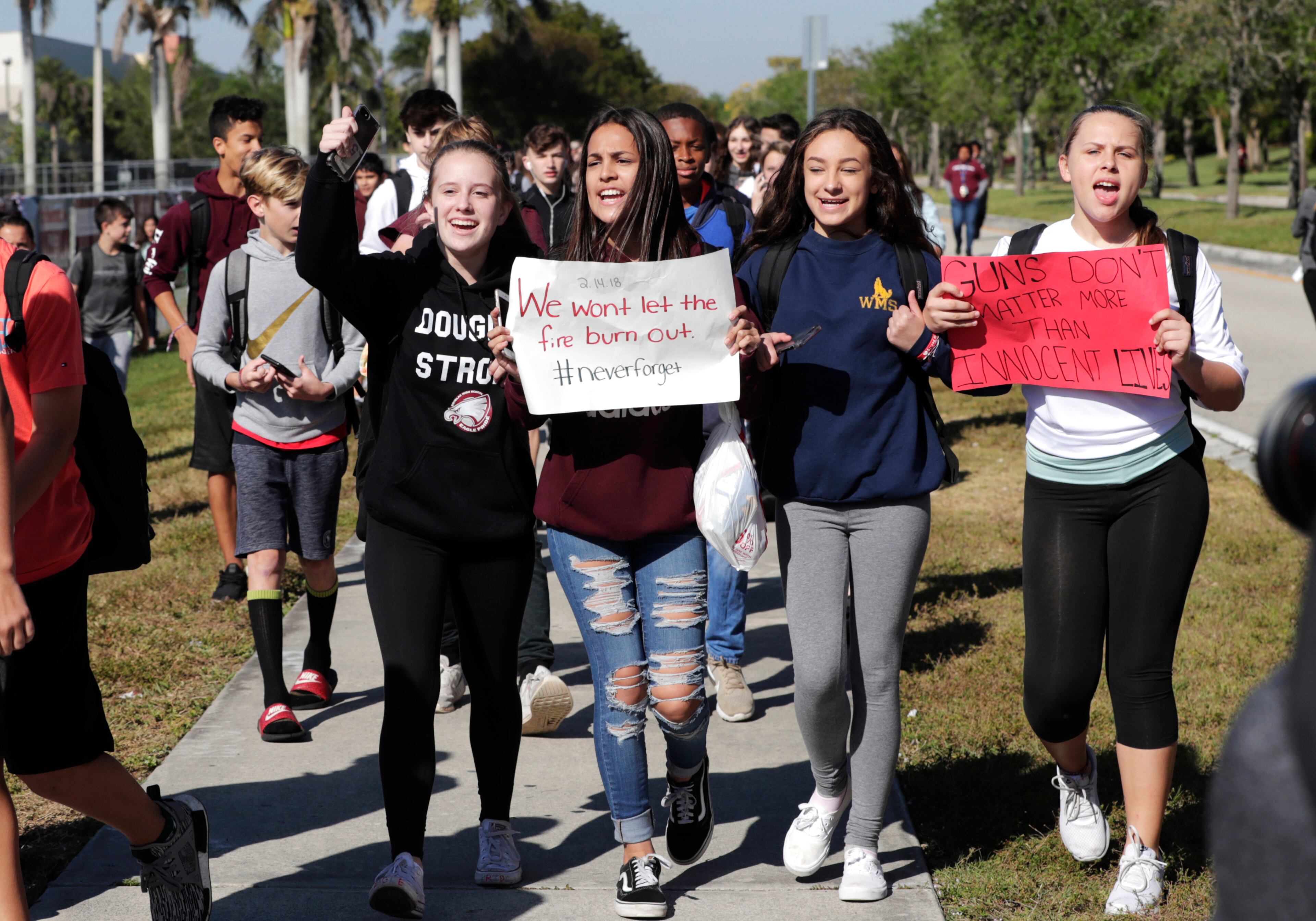Students from Westglades Middle School walk out of their school as part of a nationwide protest against gun violence, Wednesday, March 14, 2018, in Parkland, Fla. Students across the country participate in walkouts Wednesday to protest gun violence, one month after the deadly shooting inside Marjory Stoneman Douglas High School in Parkland, Fla. (AP Photo/Lynne Sladky)