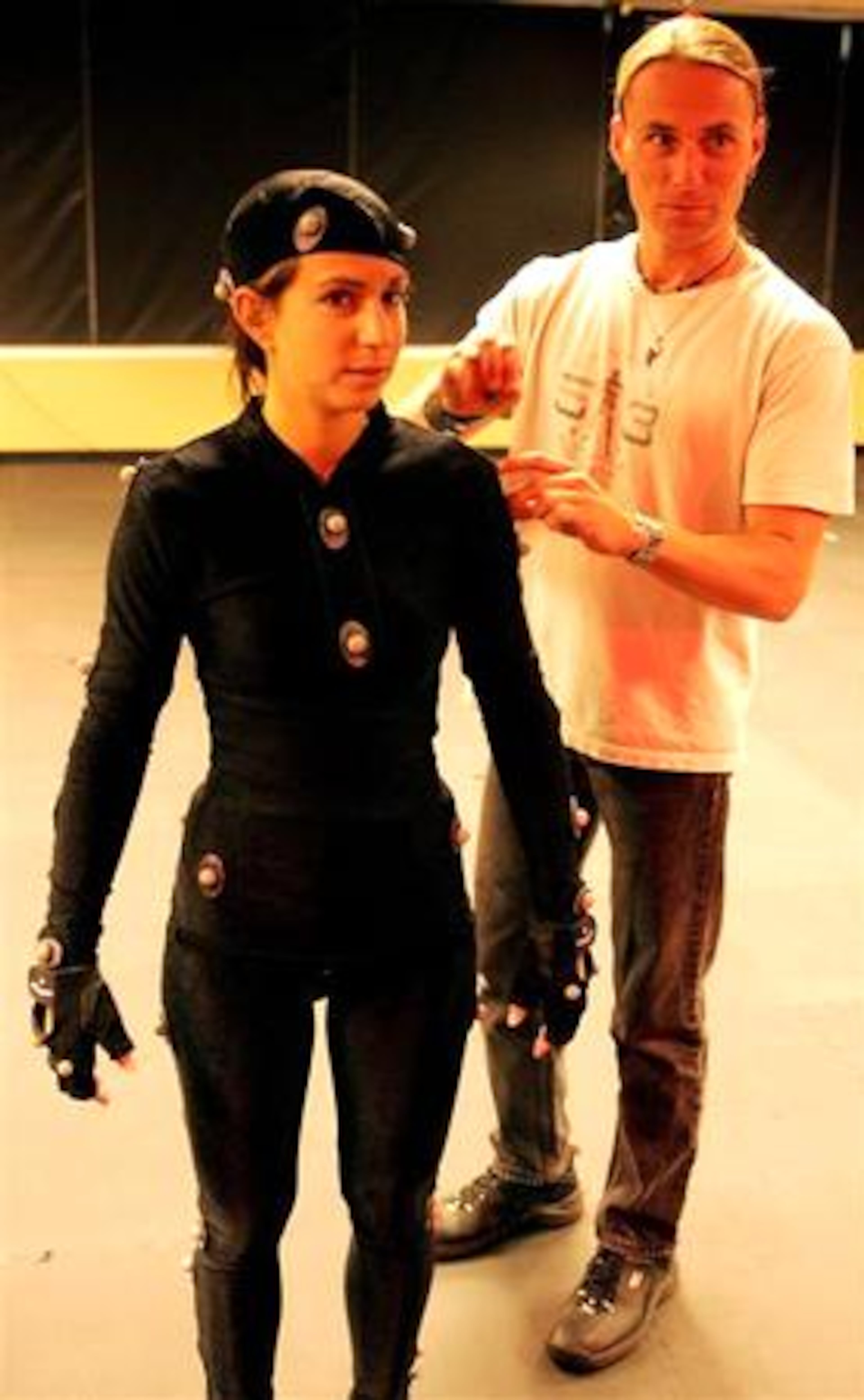 Daniel Lilleberg(right) checks "markers" on Michal Adam's suit during a motion capture session at Hi-Rez Studios in Alpharetta.