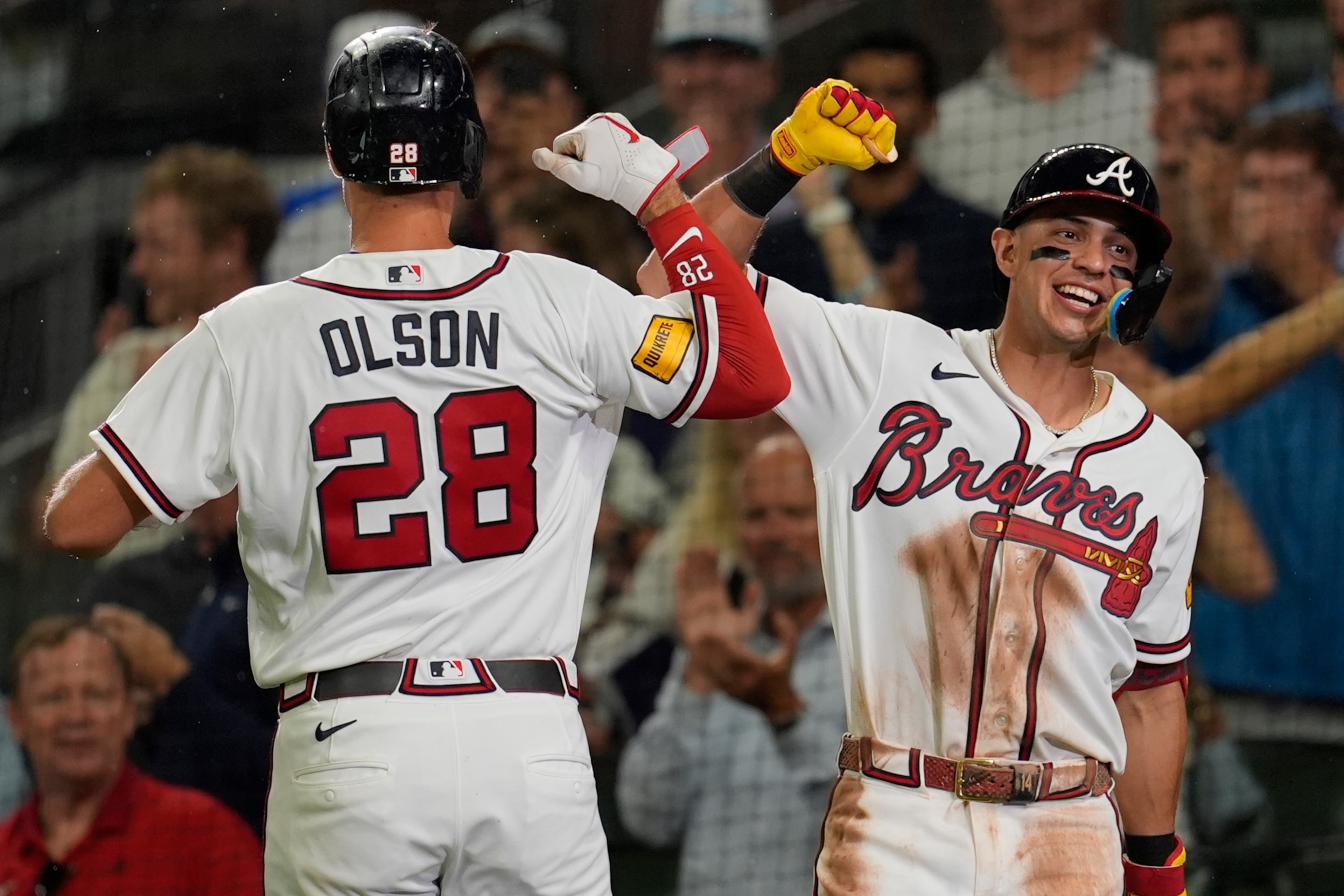Matt Olson celebrates a solo shot with teammate Mauricio Dubón. (Mike Stewart/AP)
