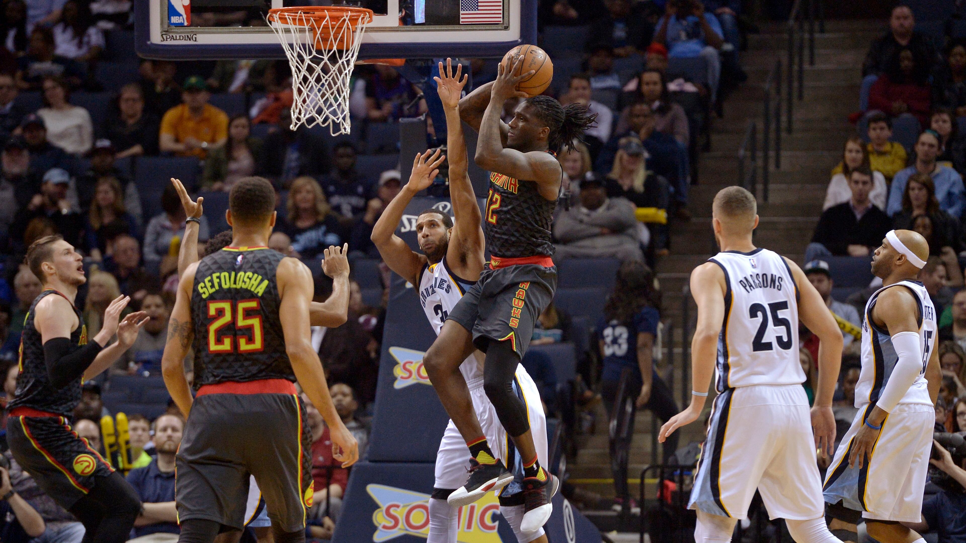 Atlanta Hawks forward Taurean Prince, center right, controls the ball next to Memphis Grizzlies forward Brandan Wright, center left, during the second half of an NBA basketball game Saturday, March 11, 2017, in Memphis, Tenn. (AP Photo/Brandon Dill)