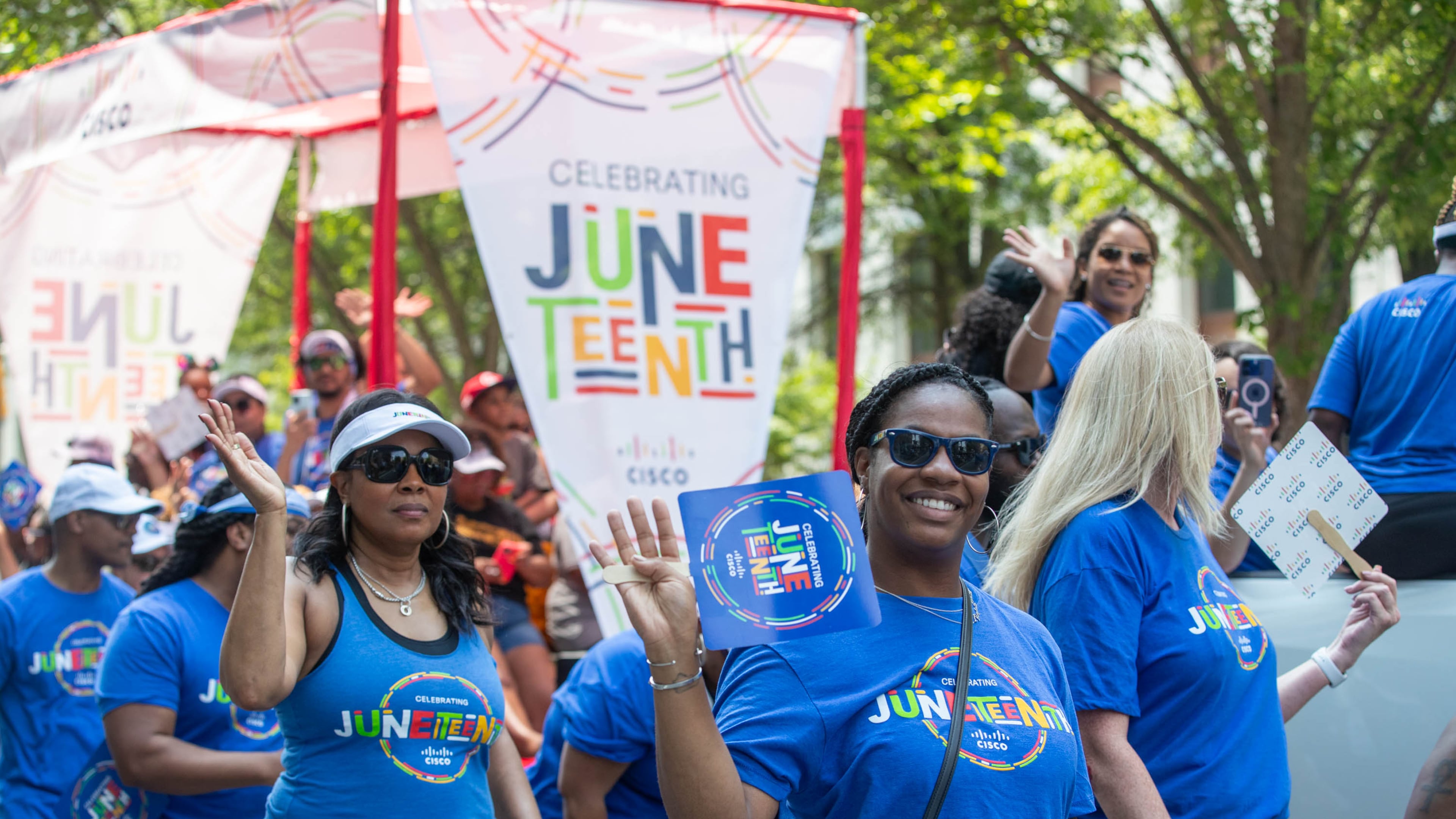 People walking in Cisco’s float at the Juneteenth Parade in Atlanta on Saturday, June 17, 2023. (Katelyn Myrick/katelyn.myrick@ajc.com)