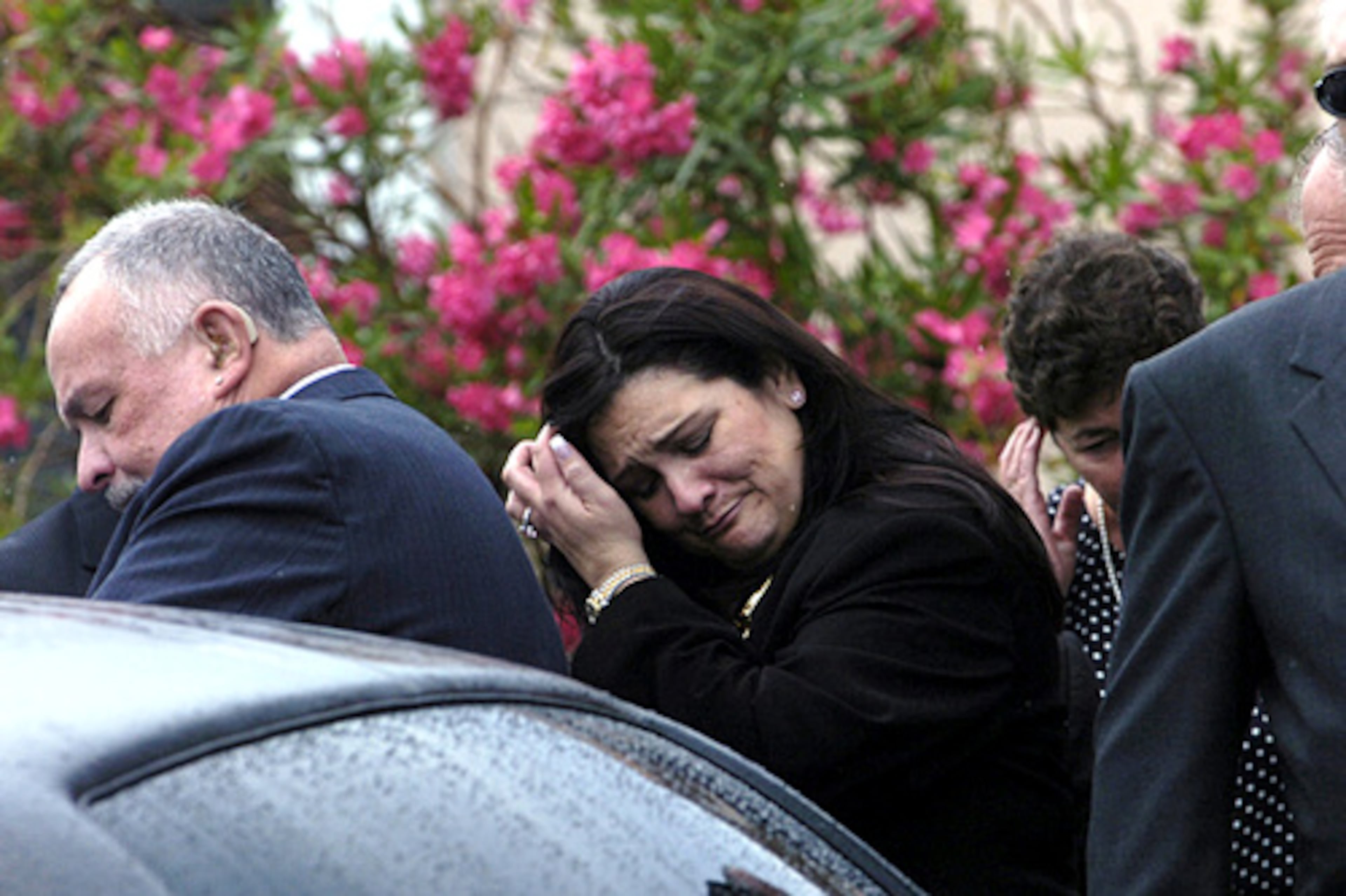Nancy Benoit's father and sister, Paul and Sandra Toffoloni, leave the memorial service in Daytona Beach, Fla.