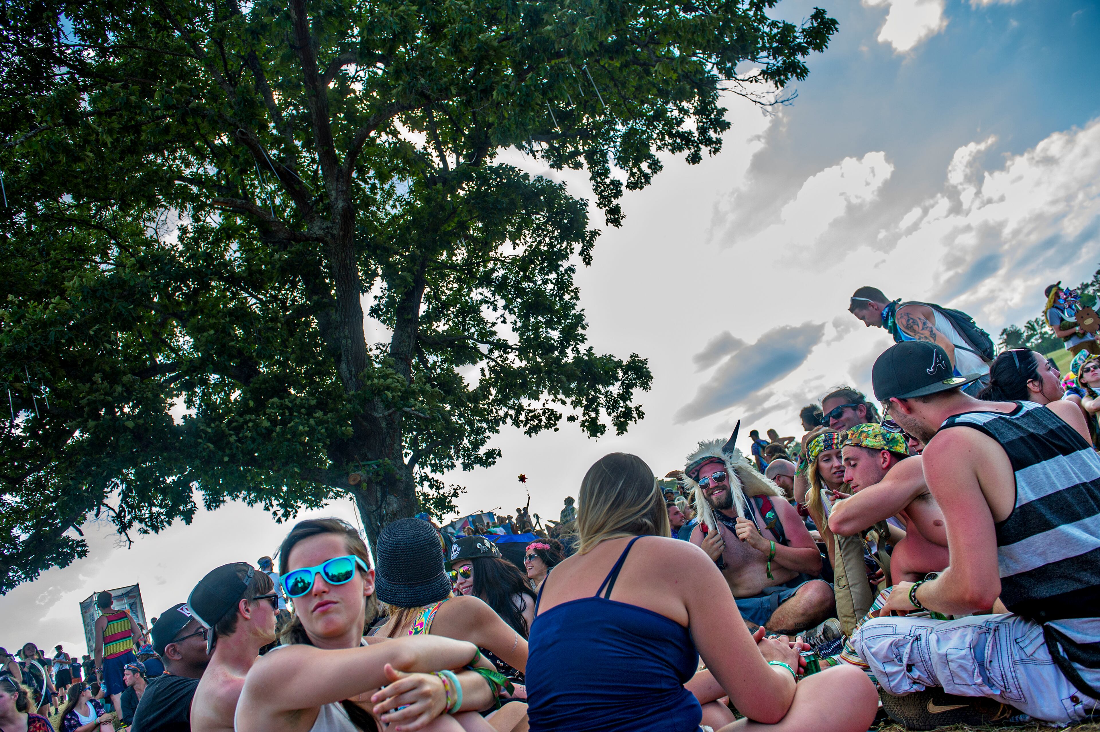 May 24, 2015 Rome - Corey Hollingsworth (right center) take shade from the sun underneath a tree during the CounterPoint Festival at Kingston Downs in Rome on Sunday, May 24, 2015. The three day music festival featured some of electronic dance music's top deejays as well as hip hop artists The Roots. JONATHAN PHILLIPS / SPECIAL