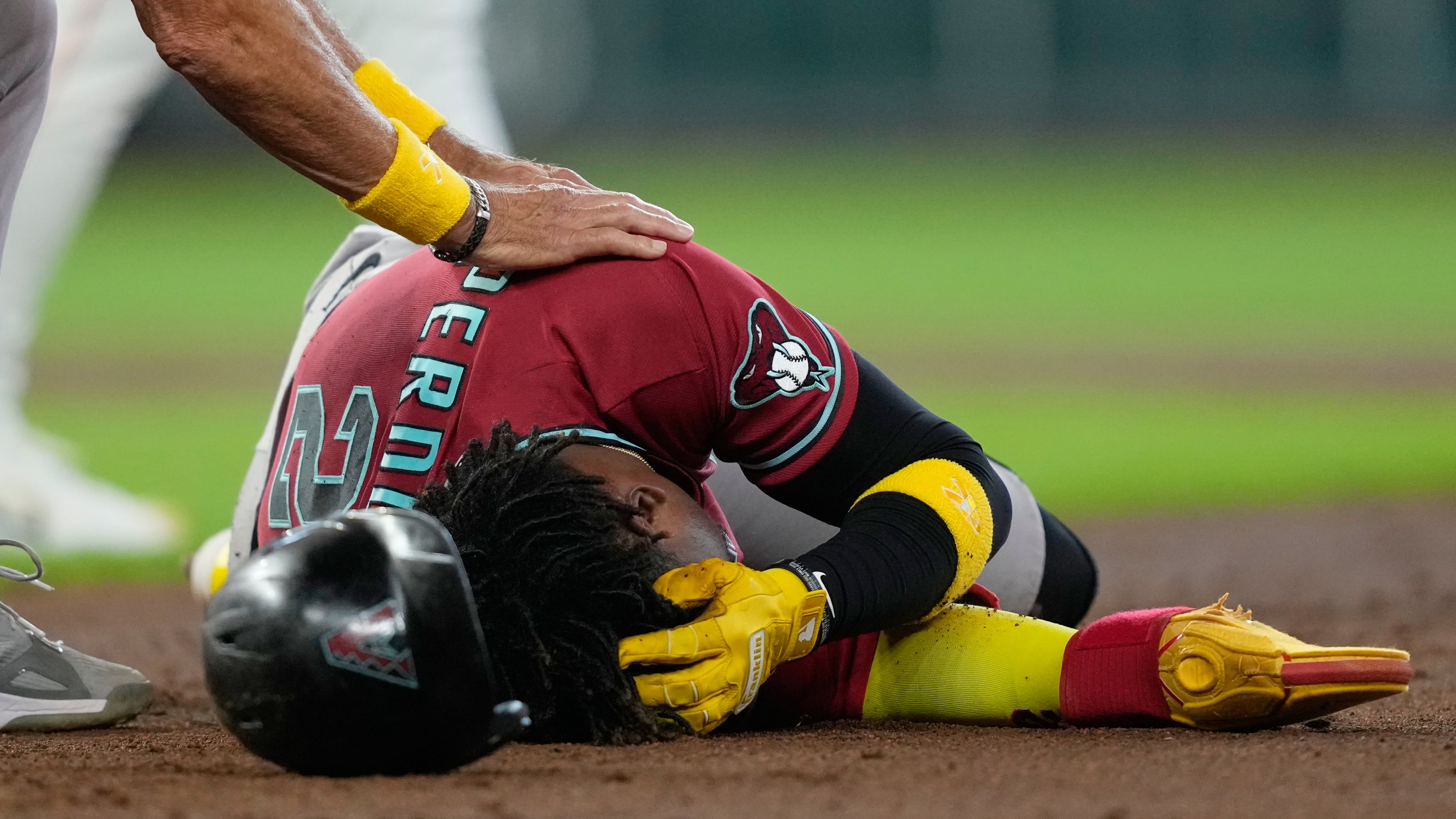 Arizona Diamondbacks' Geraldo Perdomo (2) holds his head after being hit by a line drive by Ketel Marte during the third inning of a baseball game against the Houston Astros Sunday, Sept. 6, 2026, in Houston. (AP Photo/David J. Phillip)