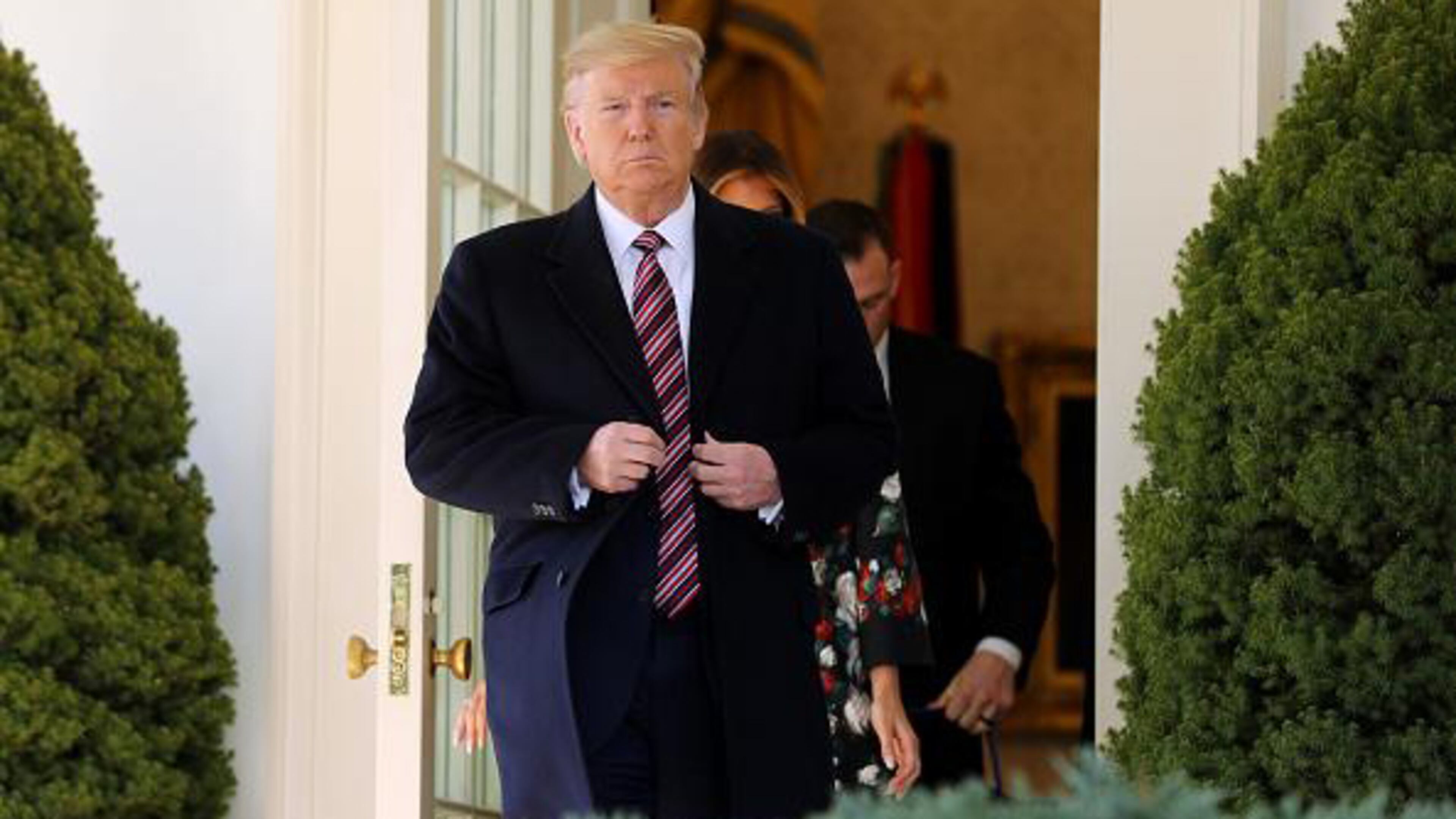 WASHINGTON, DC - NOVEMBER 25: U.S. President Donald Trump steps out of the Oval Office before posing for photographs with Conan, the U.S. military K9 that assisted in the raid that killed ISIS leader Abu Bakr al-Baghdadi, on the Rose Garden colonnade at the White House November 25, 2019 in Washington, DC. Trump talked about how the dog was a hero and said he presented the animal with a medal and a plaque. (Photo by Chip Somodevilla/Getty Images)