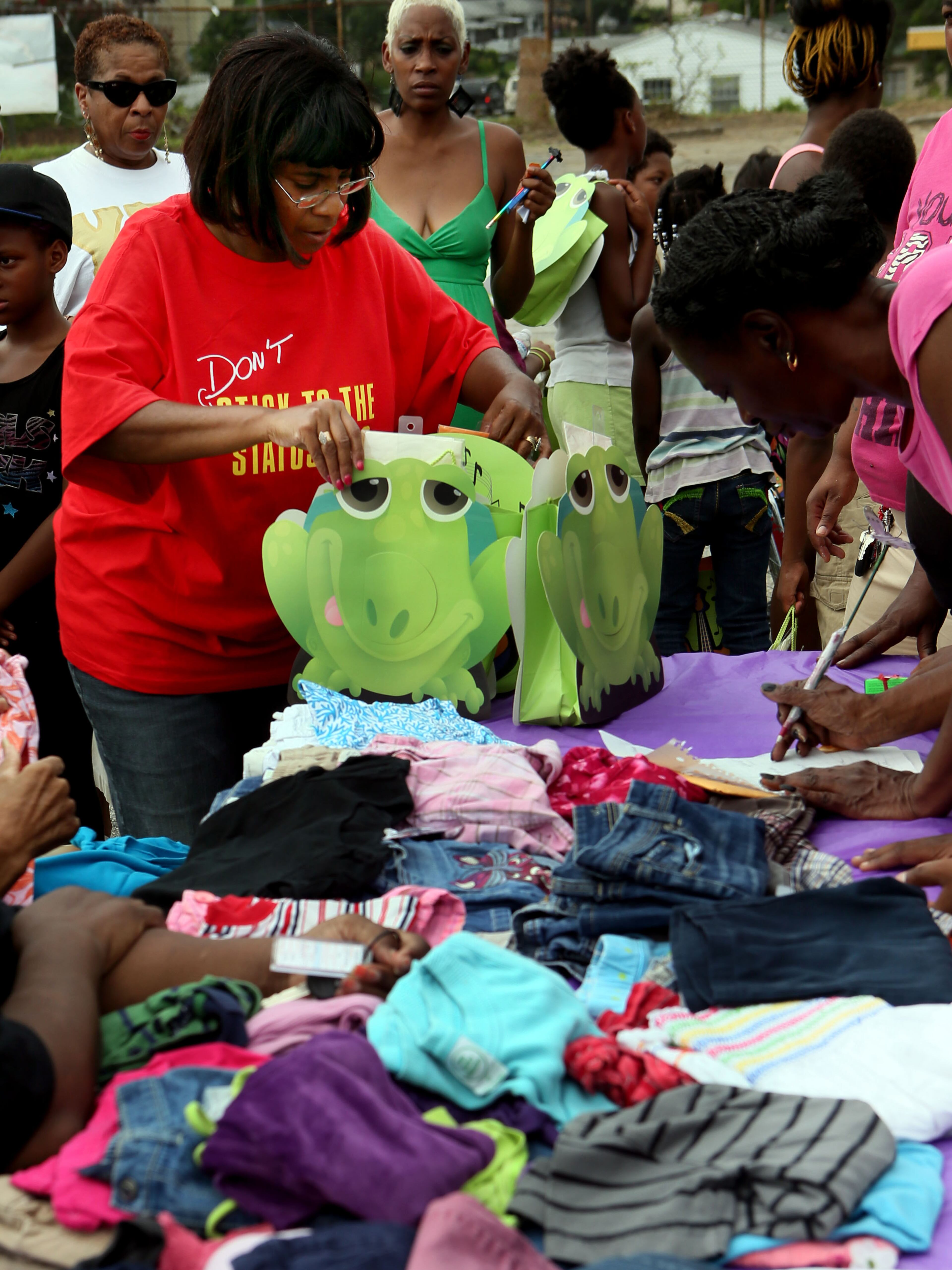 Valerie Jackson gave out clothing & supplies at the Pittsburg Ministerial Alliance booth during the 30th anniversary of National Night Out in the Pittsburg area of Atlanta on Tuesday.