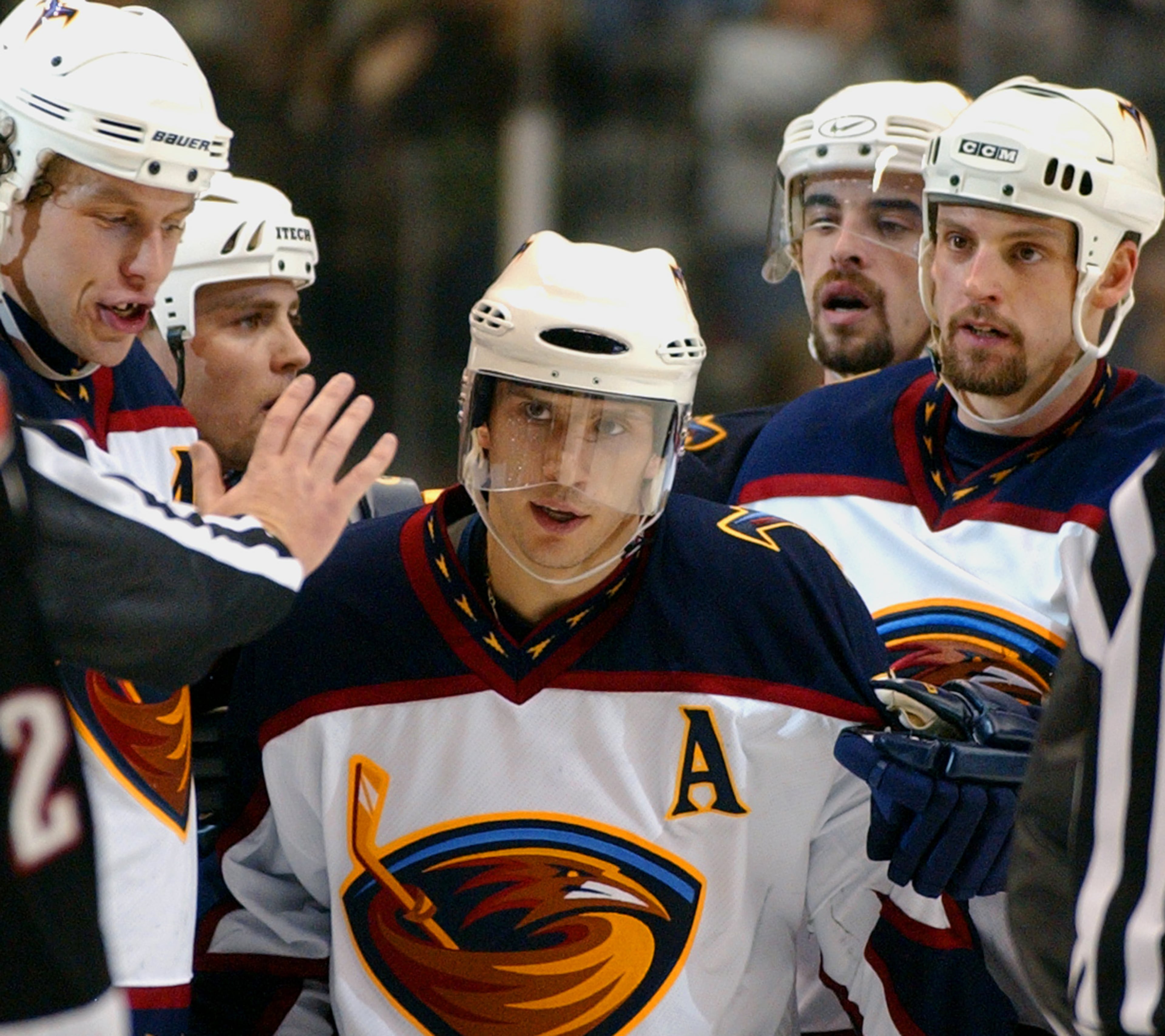 A referee cautions Atlanta Thrashers Vyacheslav Kozlov (13) of Russia, center, to stay back after a hard hit, as his teammates, Dany Heatley, of Germany, left, Chris Tamer, right, Marc Savard, left, rear, and Yannick Tremblay, right rear, help him from the ice after scoring the go-ahead goal against the Buffalo Sabres, in the third period, Saturday, March 15, 2003 at Philips Arena in Atlanta.