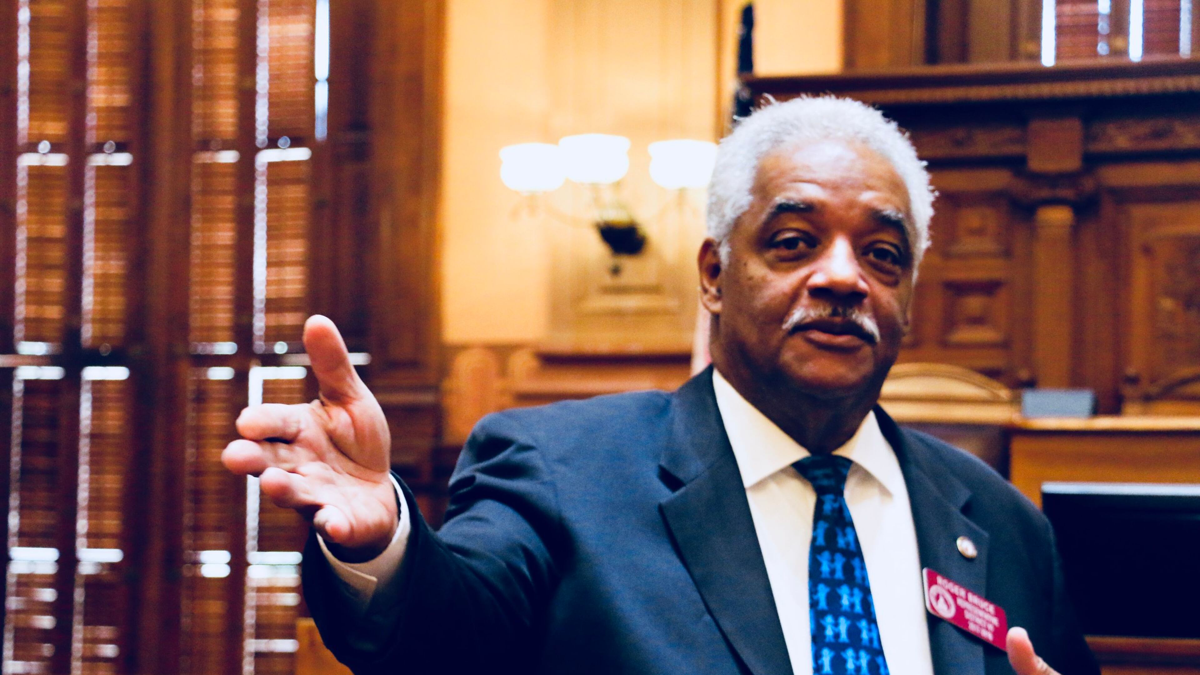 State Rep. Roger Bruce, D-Atlanta, agreed to pay a $250 fine to settle a case involving his distribution of water to voters while wearing a shirt with his name on it during the 2020 election. But Bruce said he didn’t break the law.