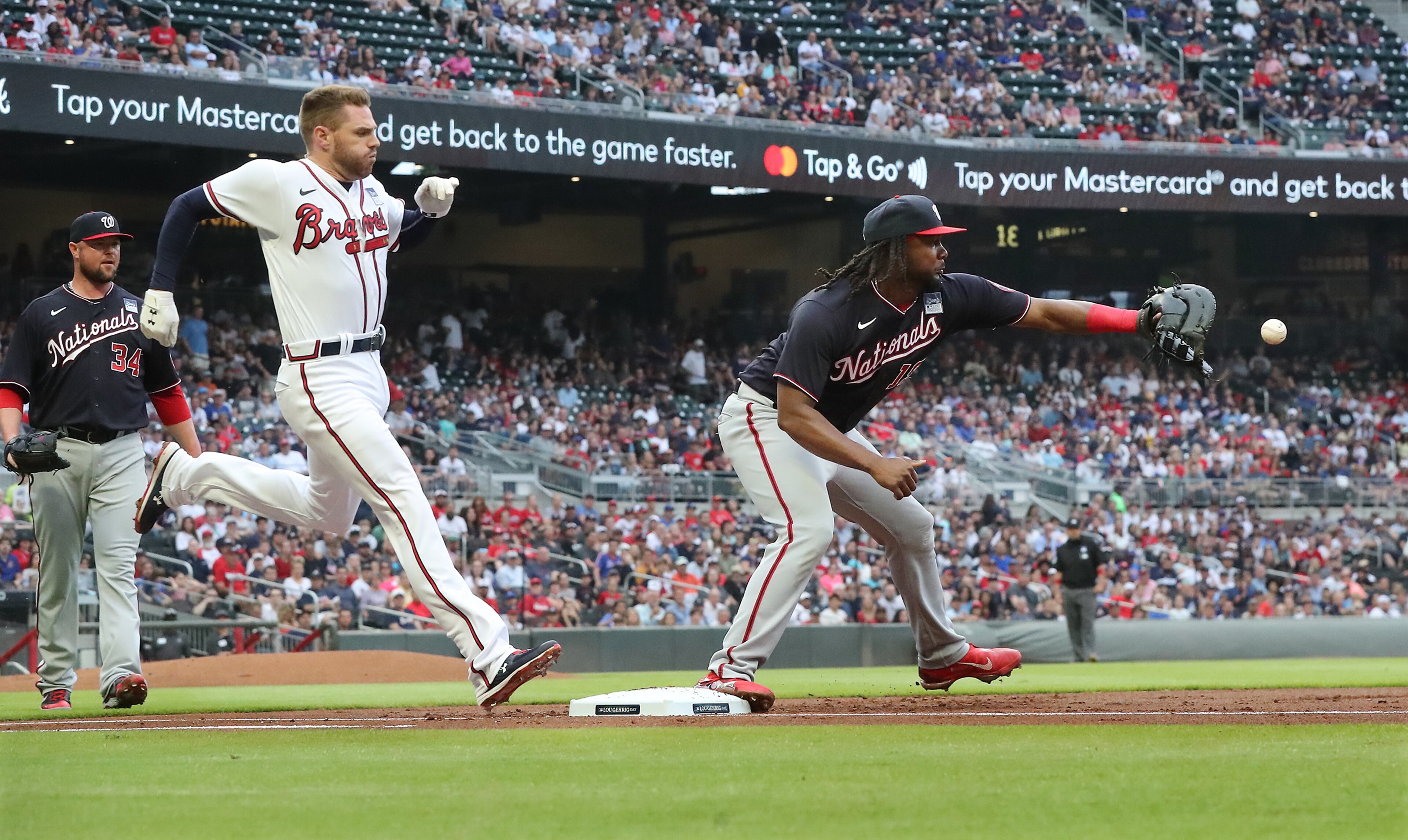 Braves batter Freddie Freeman is called out at first on his ground ball as Washington Nationals first baseman Josh Bell takes the throw during the first inning a MLB baseball game on Wednesday, Jun 2, 2021, in Atlanta. The Braves challenged the call with video replay appearing to show Freeman safe on a close call, but the call was upheld. “Curtis Compton / Curtis.Compton@ajc.com”