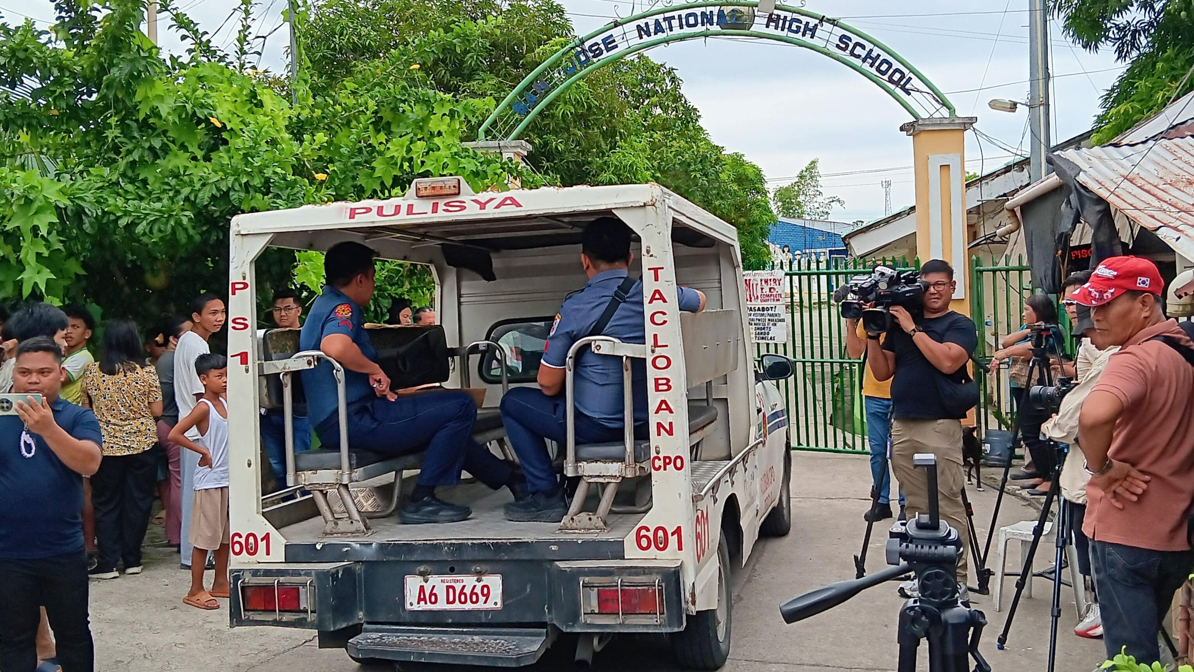A police vehicle enters San Jose National High School a day after a shooting incident inside the school in Tacloban city, central Philippines, on Monday June 22, 2026. (AP Photo/Panfilo Vallejera)