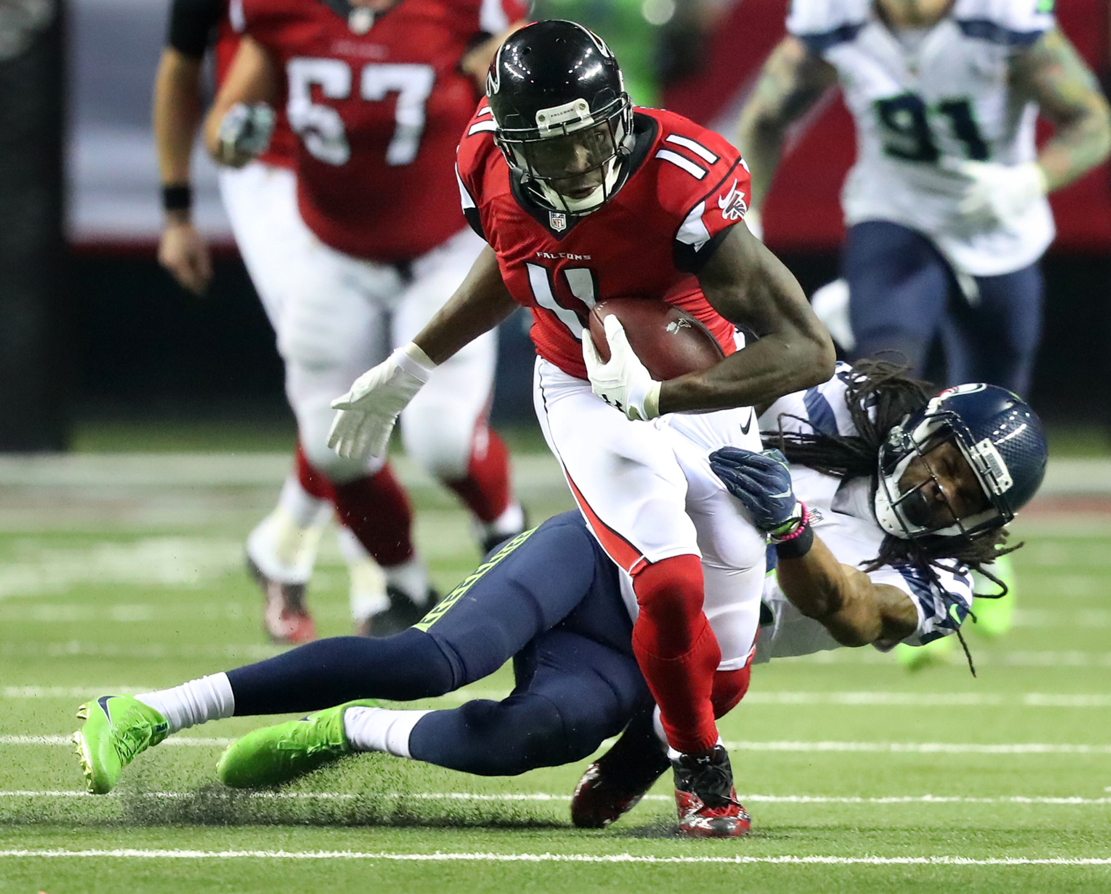 January 14, 2017, Atlanta: Falcons wide receiver Julio Jones makes a first down catch against Seahawks cornerback Richard Sherman during the third quarter in a NFL football NFC divisional playoff game on Saturday, Jan. 14, 2017, in Atlanta. Curtis Compton/ccompton@ajc.com