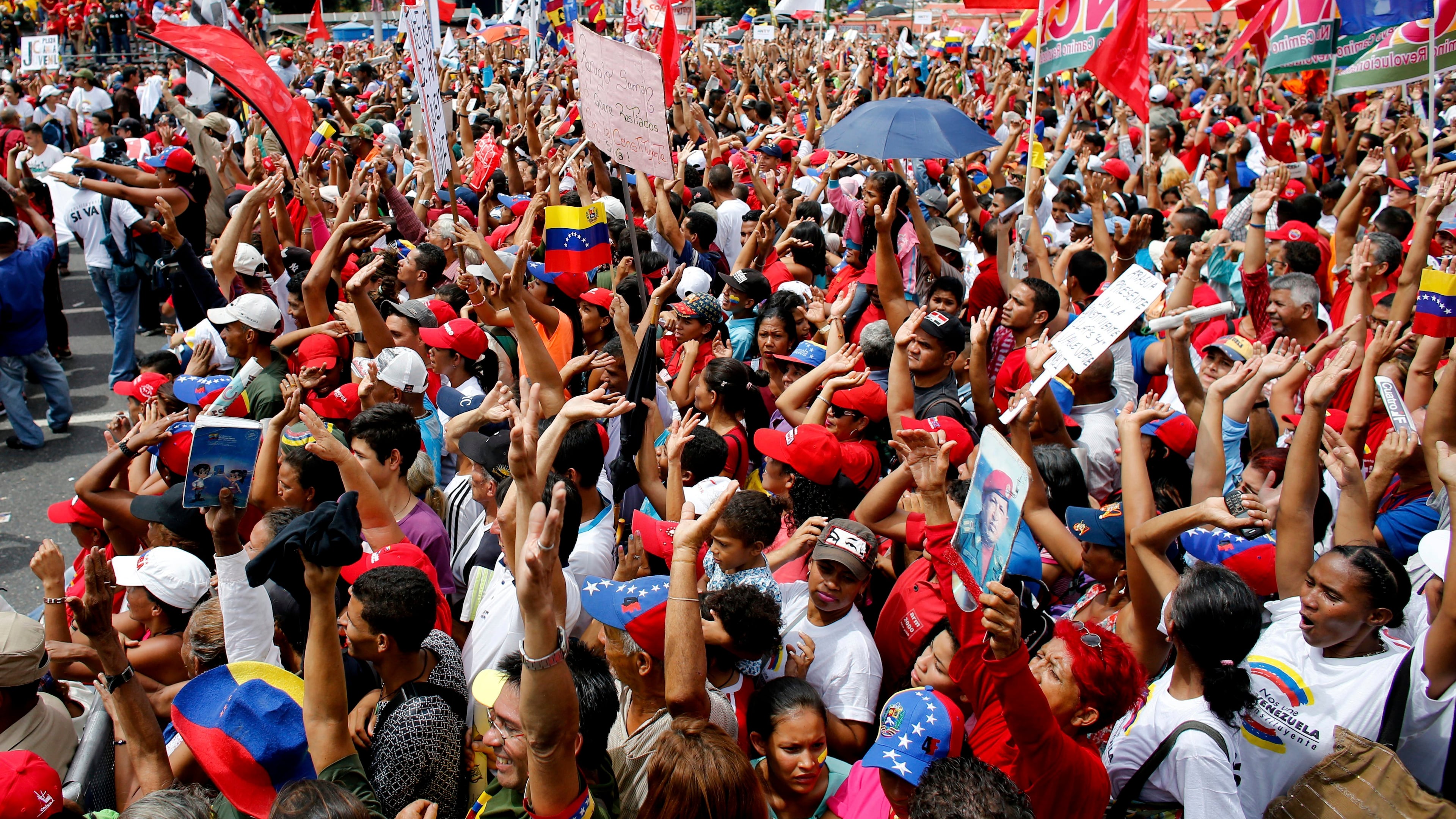 Supporters of Venezuela's President Nicolas Maduro cheer during a rally in Caracas, Venezuela, Thursday, July 27, 2017. Venezuela's President Nicolas Maduro has provoked international outcry and enraged an opposition demanding his resignation with his push to elect an assembly that will rewrite the troubled South American nation's constitution. Sunday's election will cap nearly four months of political upheaval that has left thousands detained and injured and at least 100 dead. (AP Photo/Ariana Cubillos)