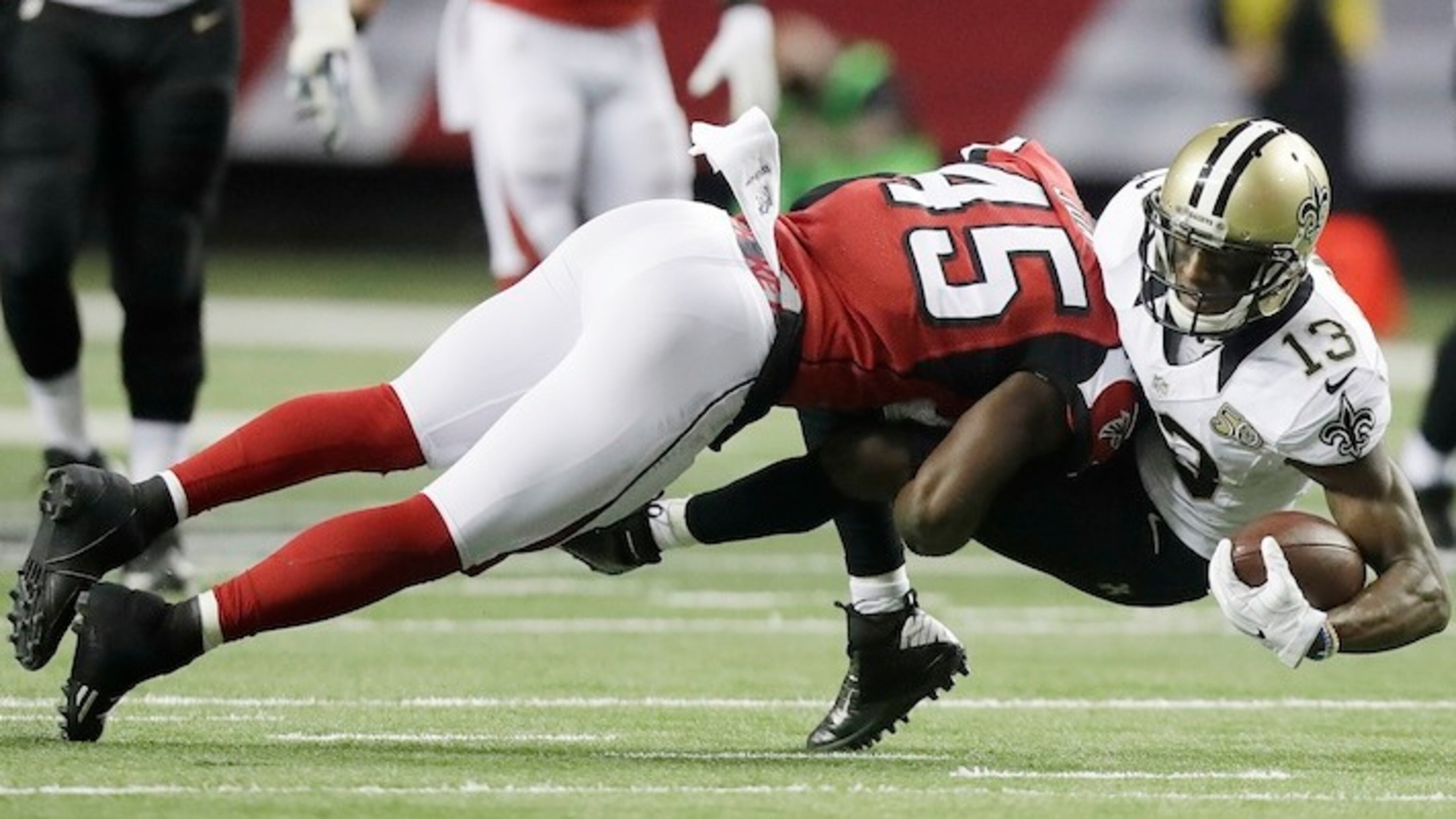 Atlanta Falcons middle linebacker Deion Jones (45) hits New Orleans Saints wide receiver Michael Thomas (13) during the first half of an NFL football game, Sunday, Jan. 1, 2017, in Atlanta. (AP Photo/David Goldman)