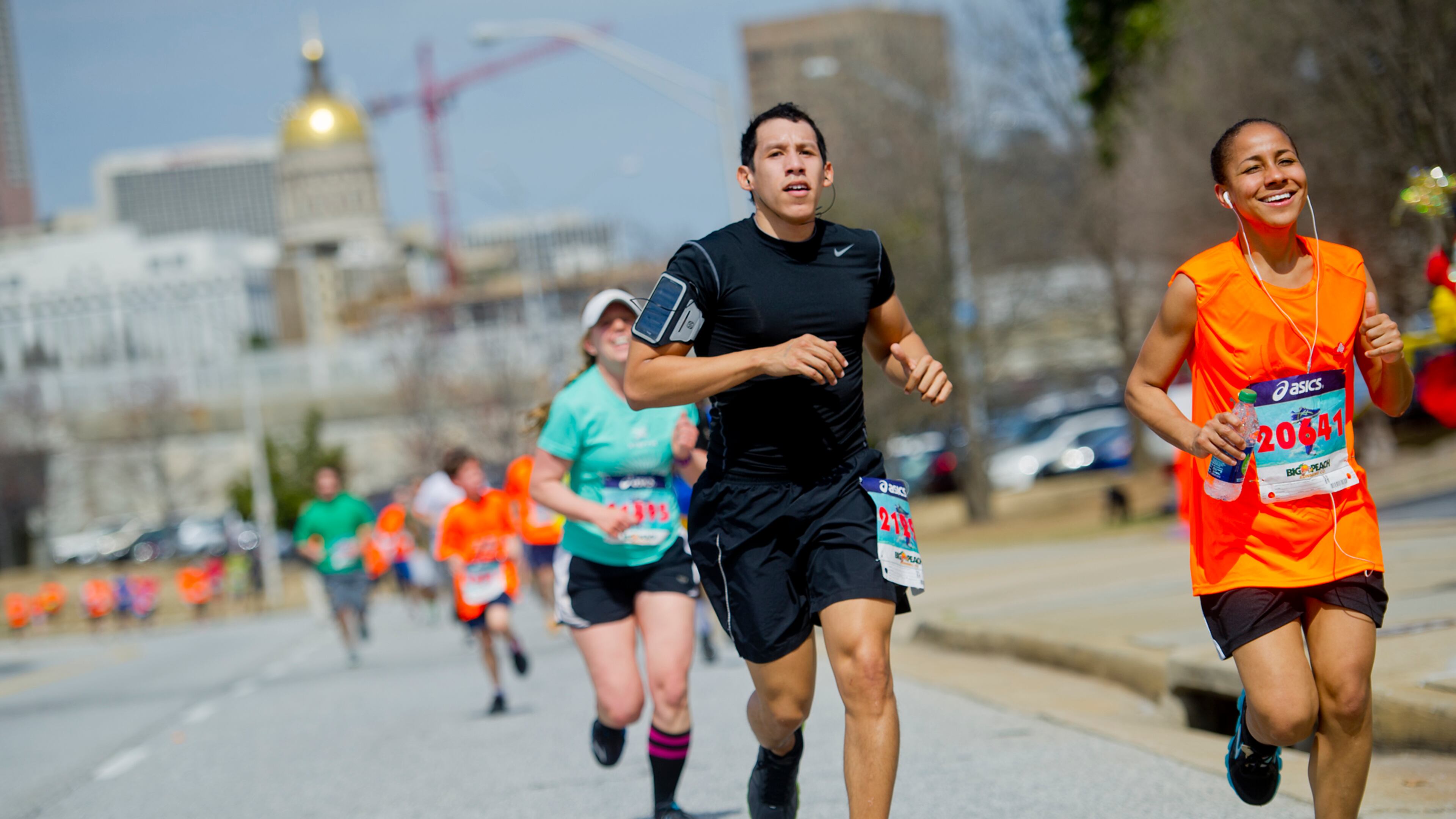 Jordan Zambrana (left) and Christiane Nolton run as they near the finish line for the Hunger Walk/Run 2013 through downtown Atlanta. More than 15,000 runners and walkers participated in the 29th annual fundraiser to raise money for the Atlanta Community Food Bank and five other non-profit organizations.