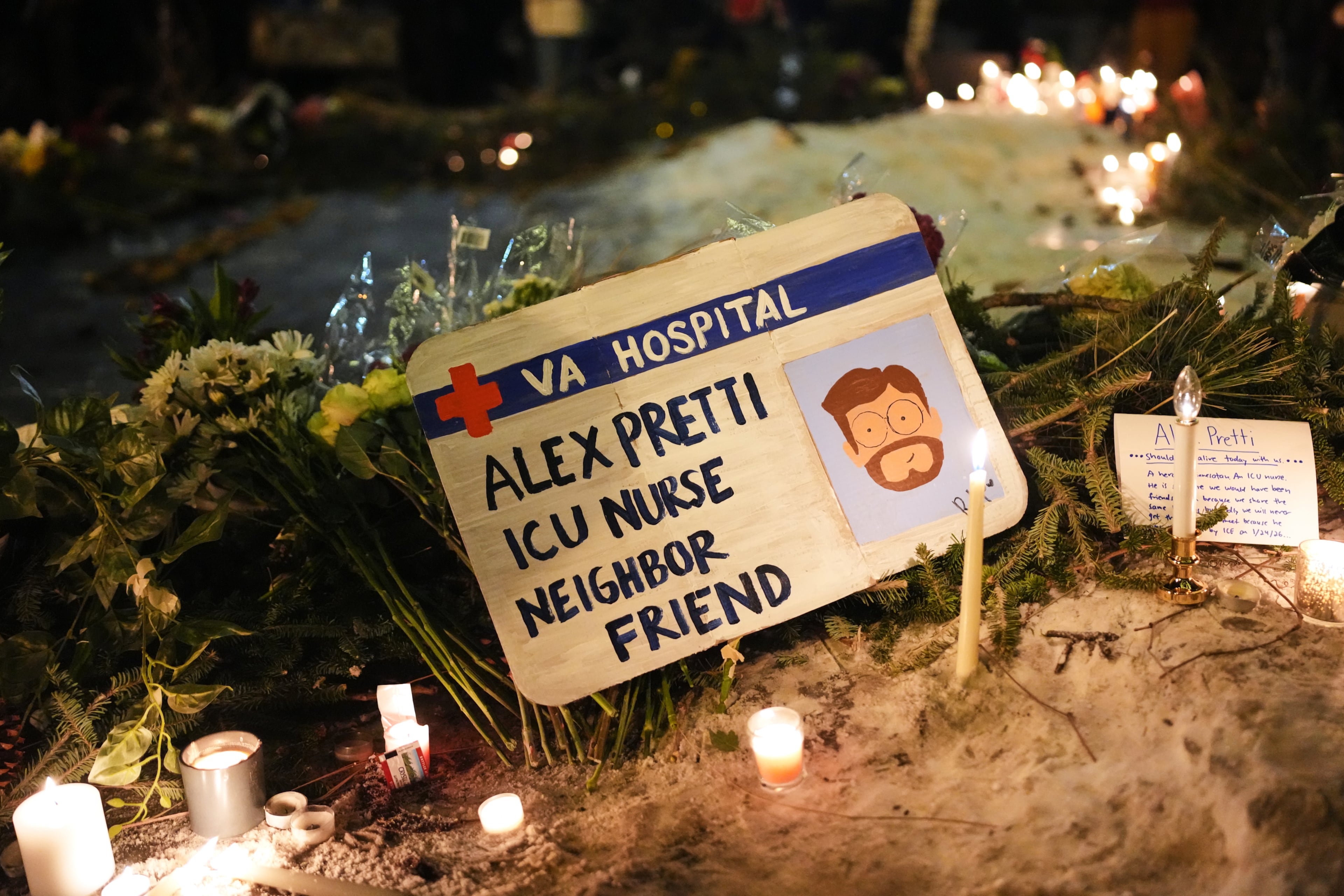 A sign for 37-year-old Alex Pretti, who was fatally shot by a U.S. Border Patrol officer Saturday, Jan. 24, 2026, is displayed during a vigil Saturday night in Minneapolis. (Adam Gray/AP)