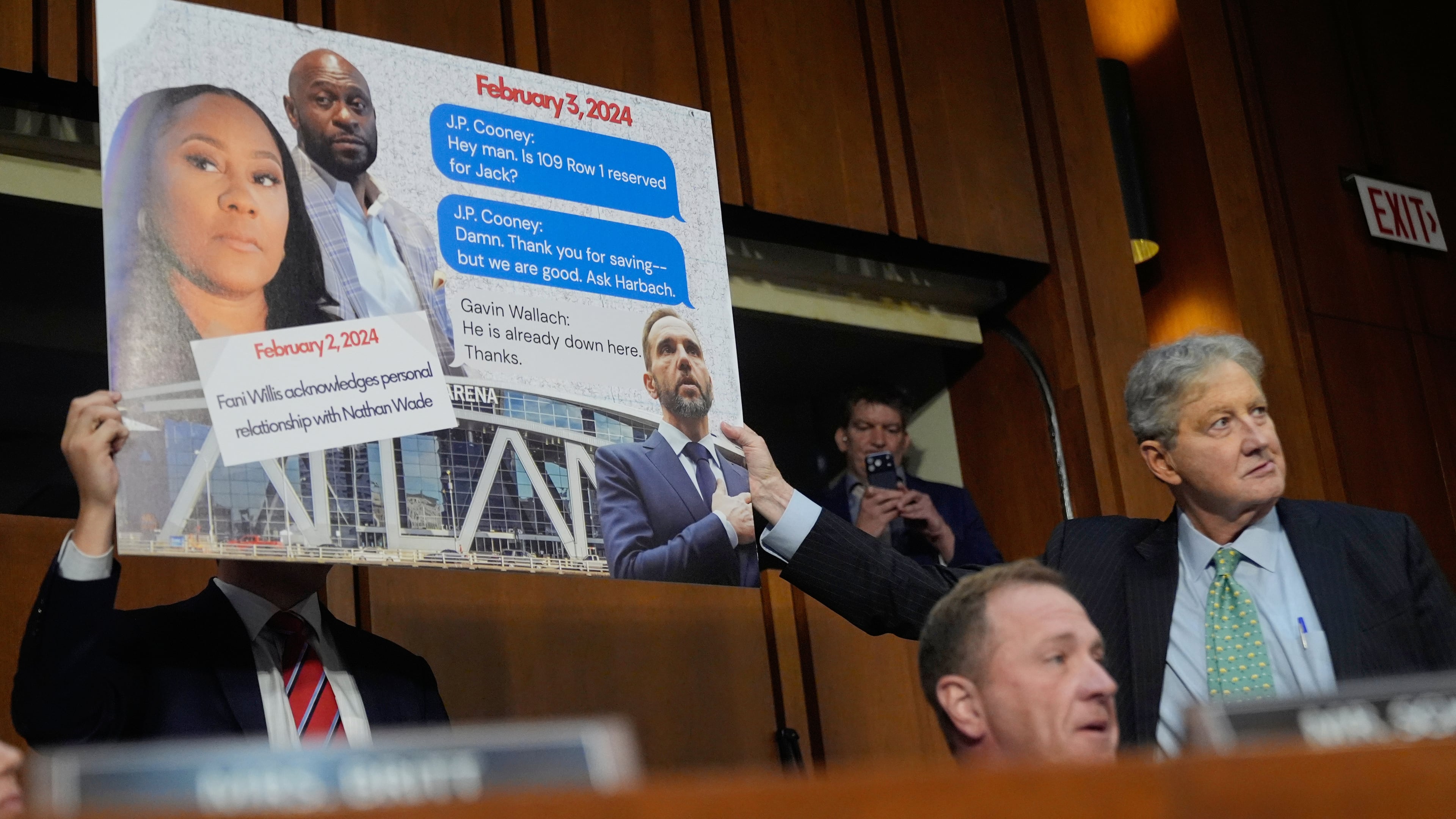 Sen. Eric Schmitt, R-Mo, seated right, with Sen. John Kennedy, R-La., standing right, during a discussion about text messages with former special counsel Jack Smith, as Smith testifies before the Senate Judiciary Committee on Capitol Hill, in Washington, Tuesday, Sept. 29, 2026, as they probe his investigation of President Trump. (AP Photo/Manuel Balce Ceneta)