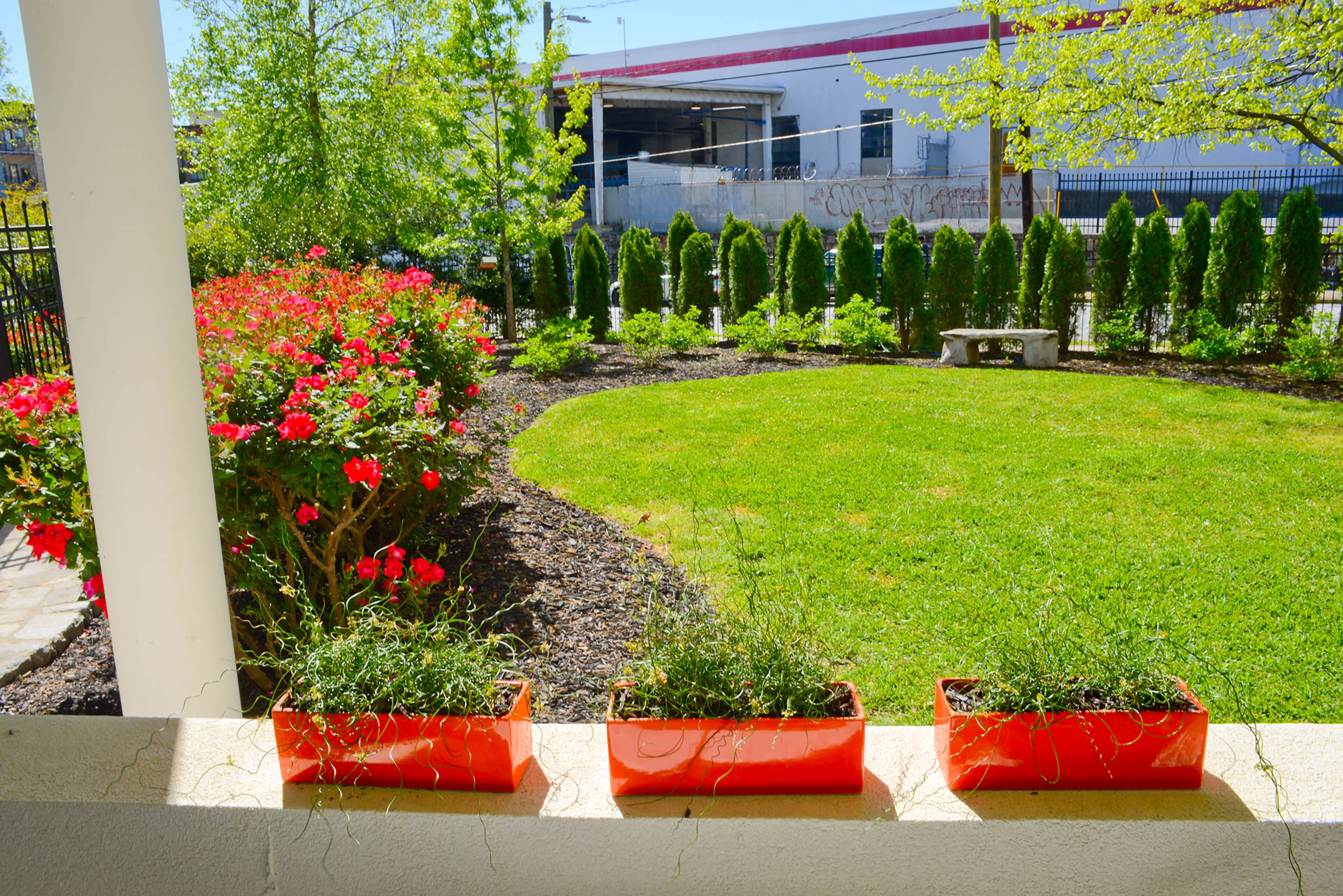 Henry has access to this yard, owned and maintained by Sager Lofts, where he gardens and plays with his grandkids. He often drinks coffee on his end-unit porch overlooking the yard.